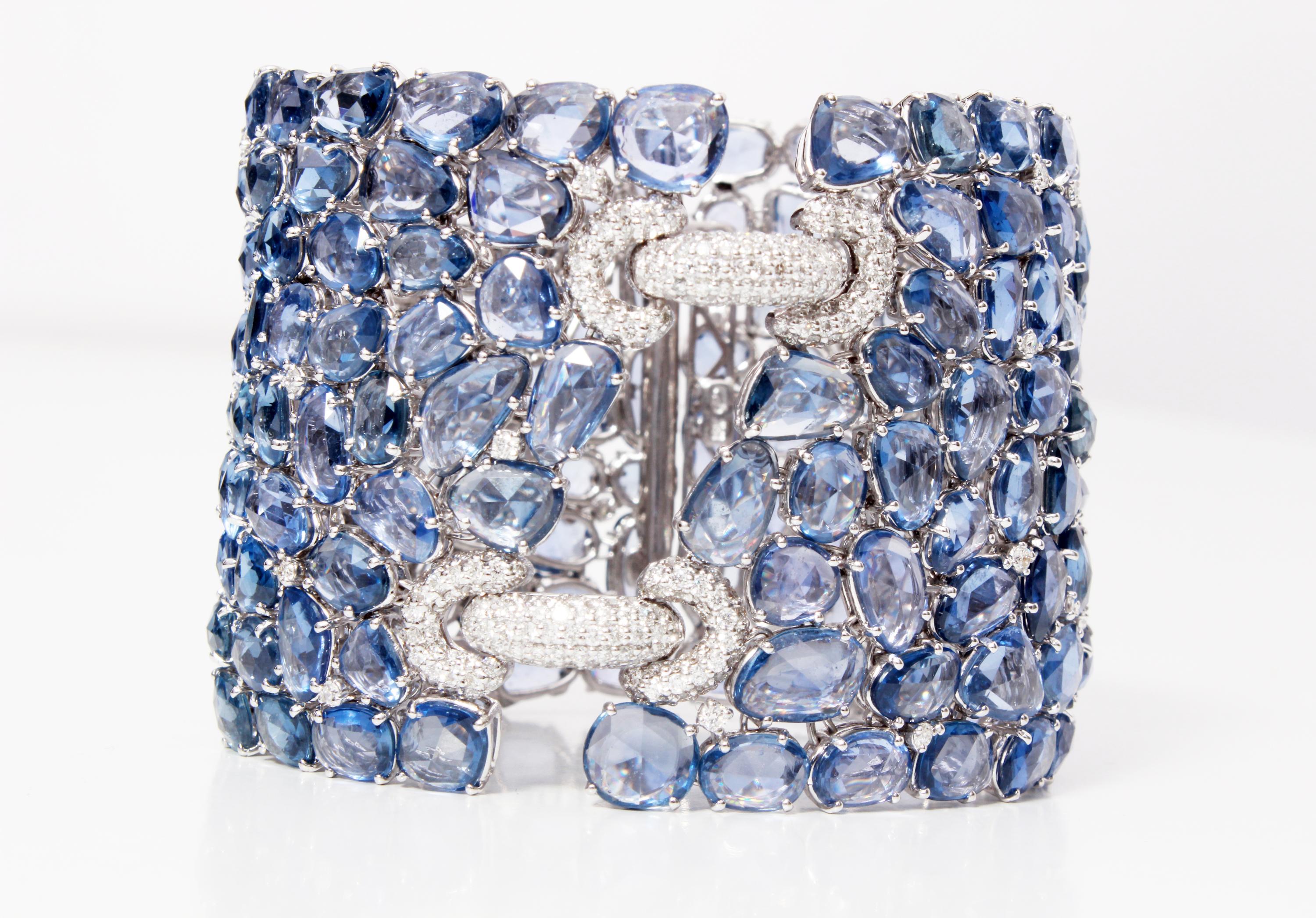 This astonishing bracelet has 196 pieces of Rose Cut Blue Sapphires that weigh 170.52 carats and 265 pieces of Round Cut White Diamonds that weigh 3.32 carats. The bracelet is made in 18K White Gold and weighs approximately 115.342 grams.