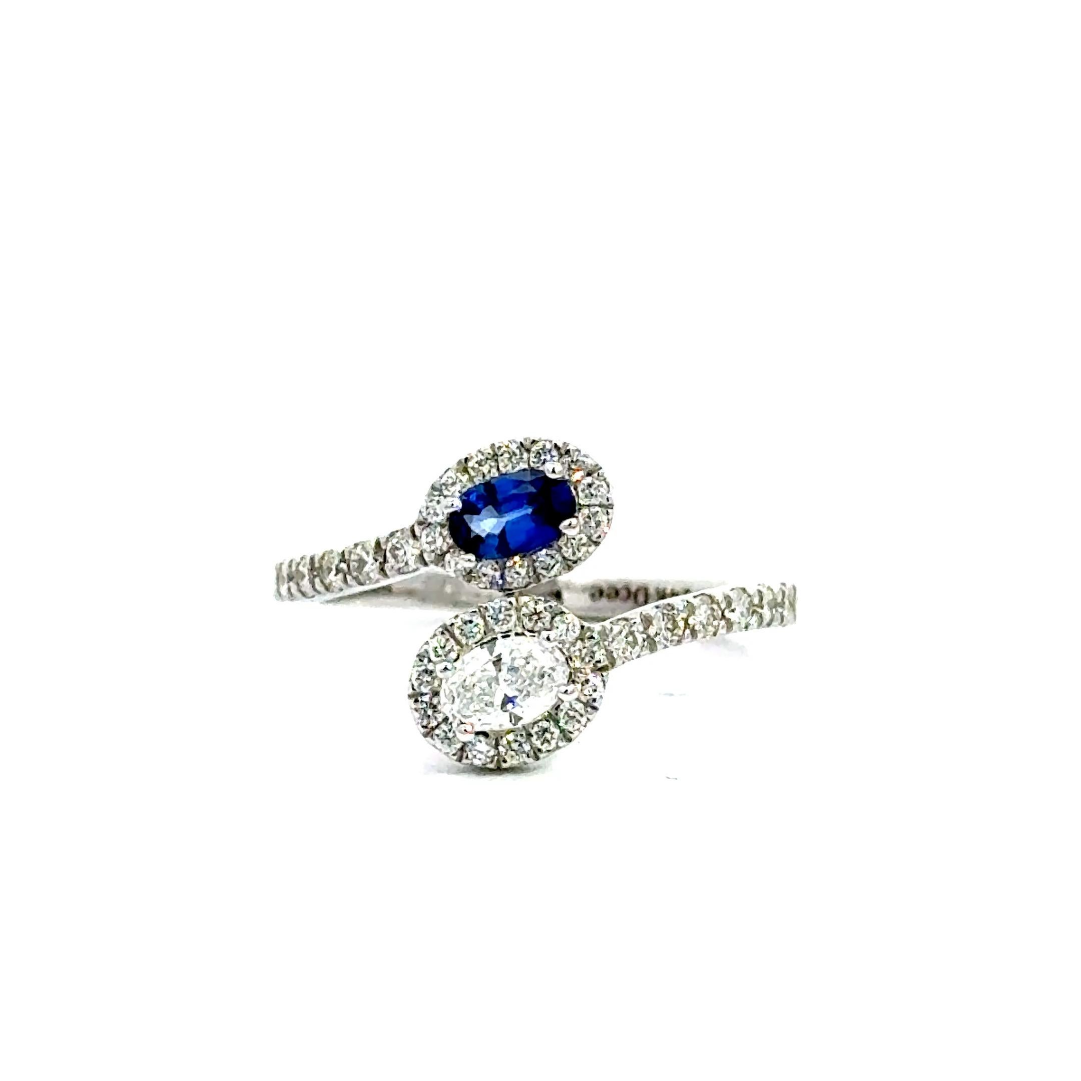 Gracefully modern with timeless elegance, this Blue Sapphire and Diamond Bypass Ring is stunning symbol of connection and individuality . Featuring a captivating deep blue sapphire paired with a brilliant white diamond, the bypass design gently
