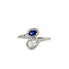Blue Sapphire and Diamond By Pass Engagement Ring In 14 karat White Gold.