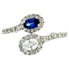 Blue Sapphire and Diamond By Pass Engagement Ring In 14 karat White Gold.