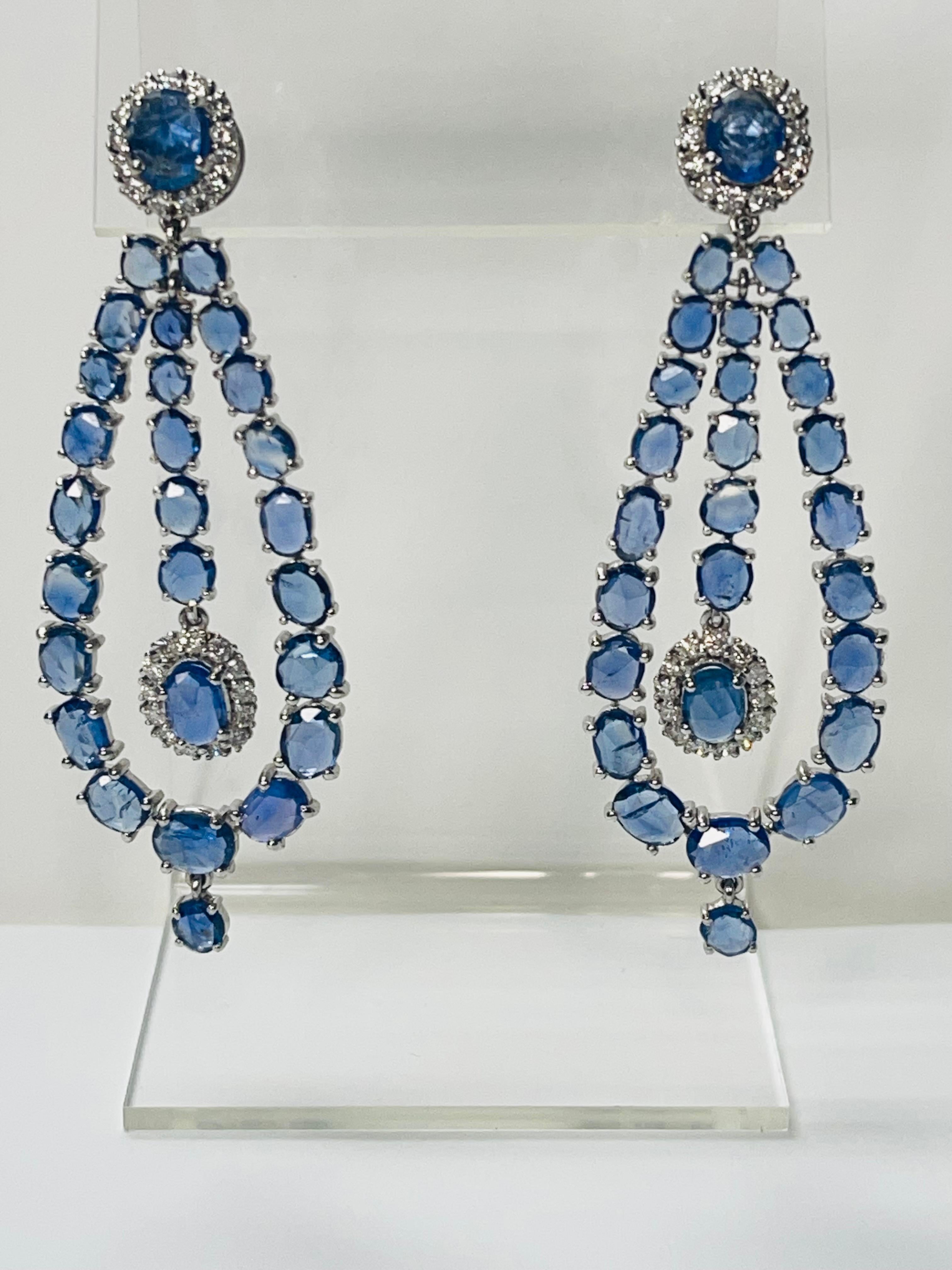 These gorgeous blue sapphire and diamond chandelier earrings are beautifully hand crafted in 18k white gold. 

The details are as follows : 

Blue sapphire weight : 15.25 carats 
Diamond weight : 1.68 carats ( G color and VS clarity ) 
Gold : 17.300