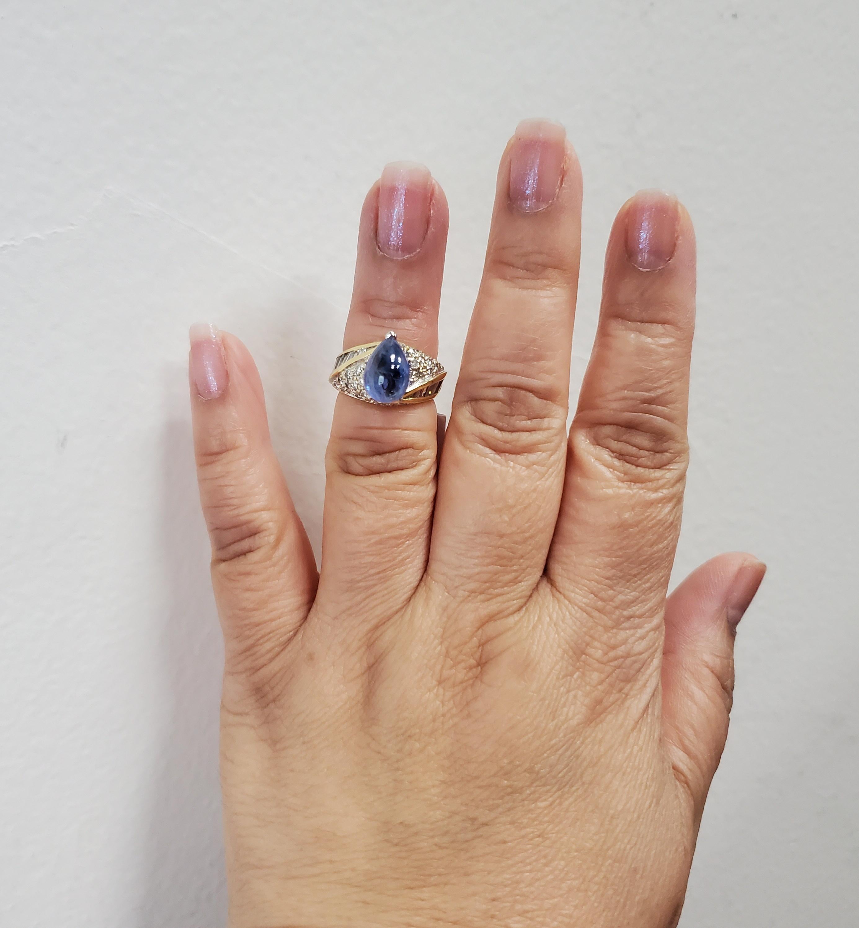 Gorgeous 4.41 ct. blue sapphire cabochon pear shape with 1.00 ct. good quality, white, and bright diamond rounds and baguettes.  Handmade in 18k yellow gold.  Ring size 5.