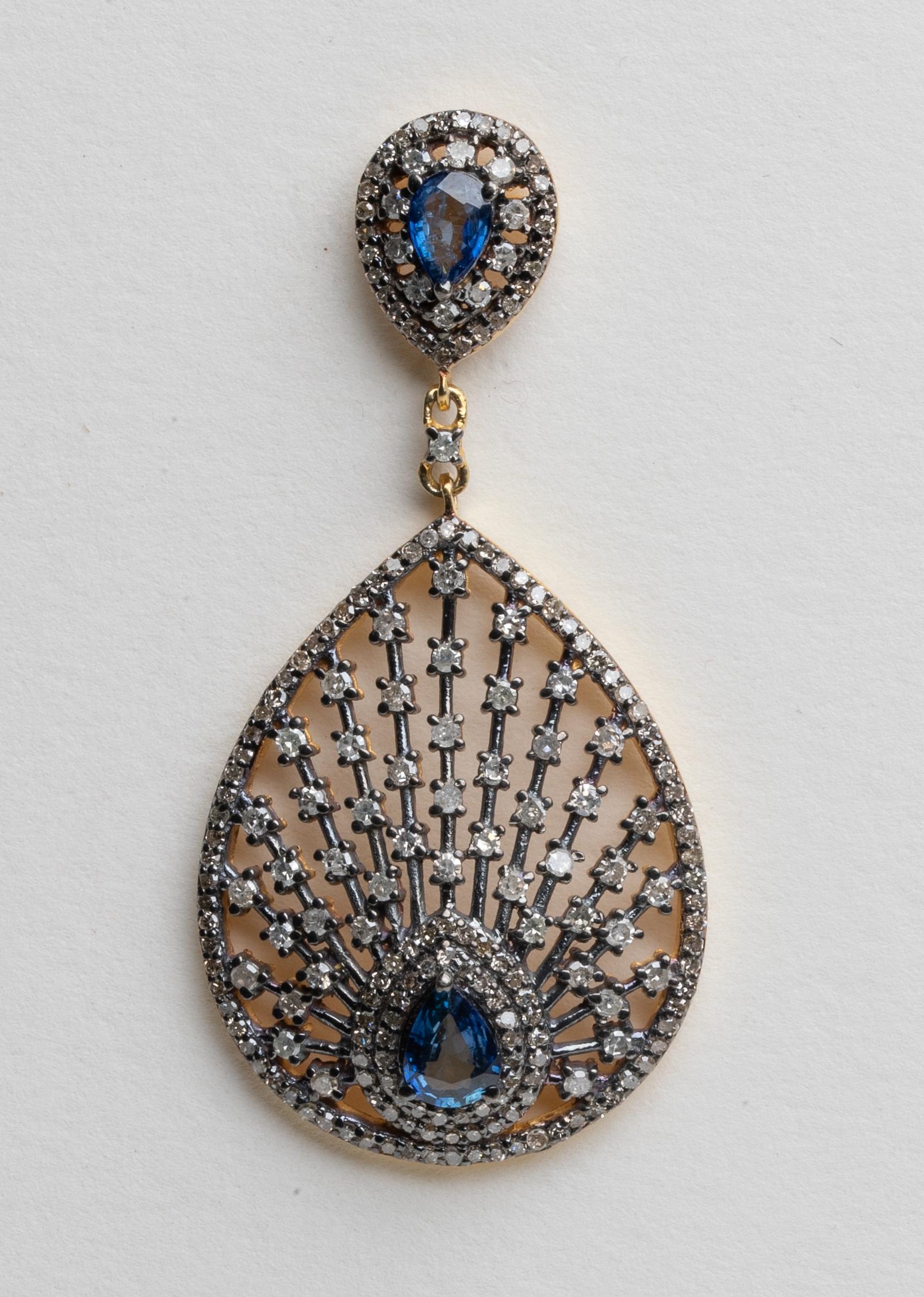A lovely pear-shaped post and drop earring with faceted blue sapphires and round-cut diamonds radiating outward.  Set in vermeil with an 18K gold post for pierced ears.  Carat weight of sapphires is 2.15; diamonds total 3.34 carats.