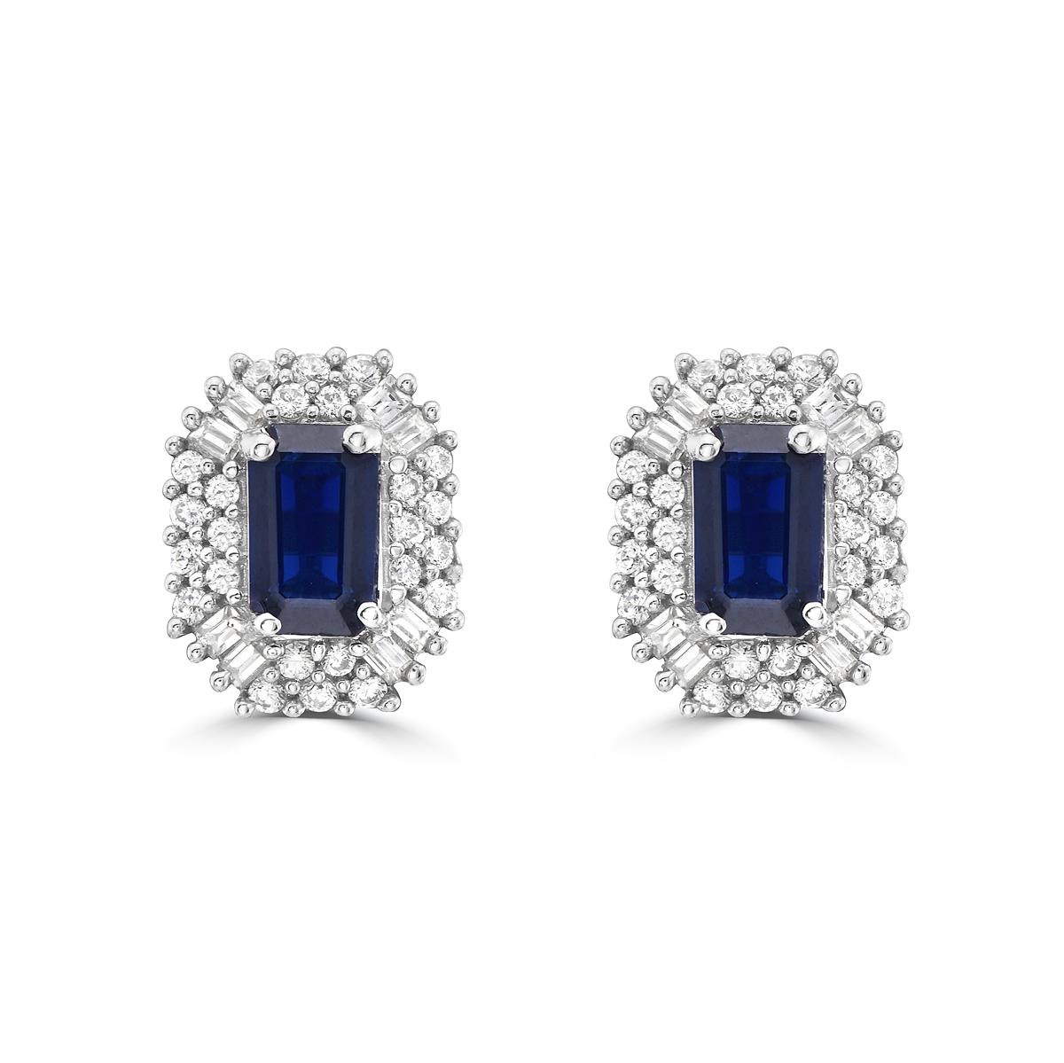 Indulge in luxury with our Blue Sapphire and Diamond Double Halo Stud Earrings. Featuring stunning baguette-cut sapphires, these sapphire stud earrings exude sophistication and exclusivity. The dazzling double halo design with accompanying diamonds