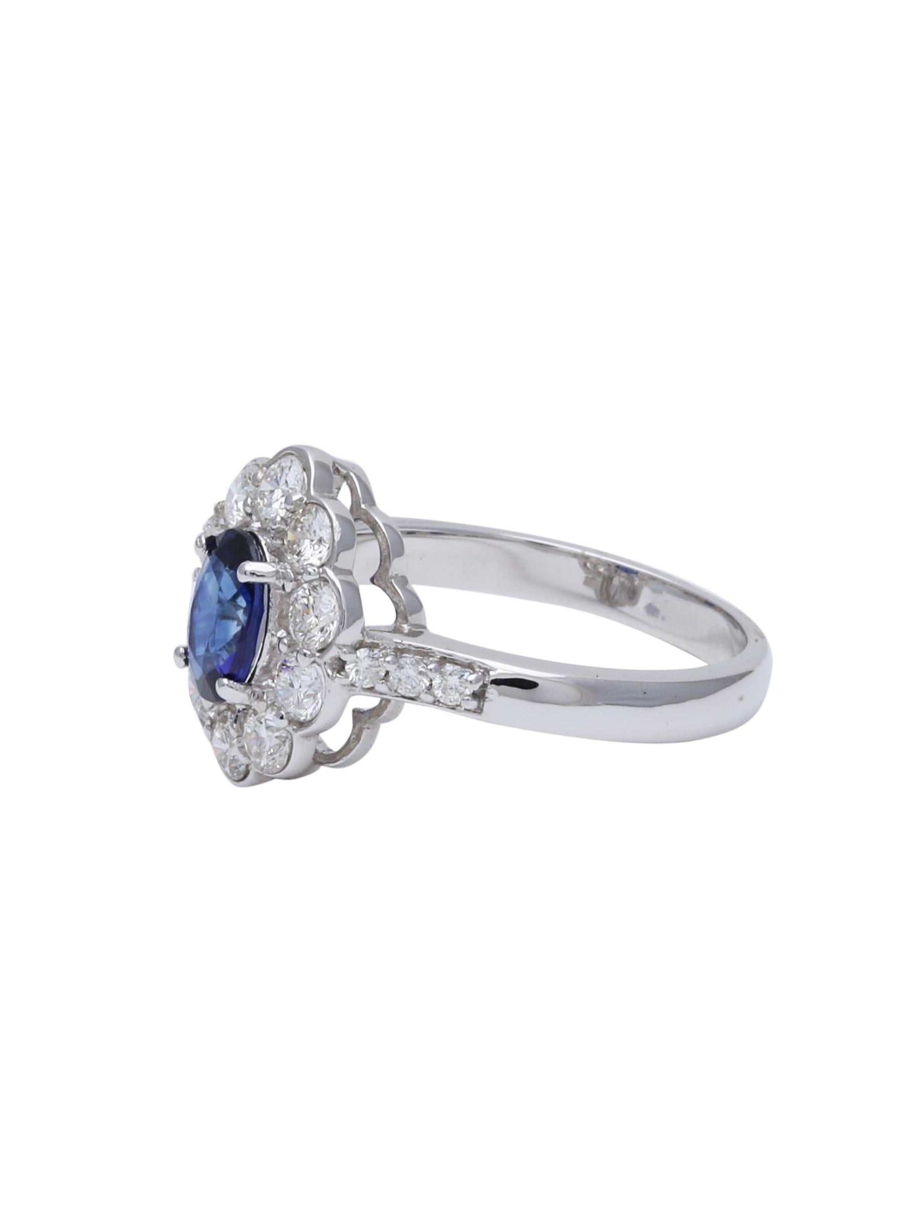 A perfect engagement ring or Anniversary present for her. A beautiful blue Sapphire and Diamond Halo ring set in 18K White Gold. The Blue Sapphire in the ring weighs 0.82 carats and diamonds weigh 0.86 carats. Its one of the oldest yet the classiest