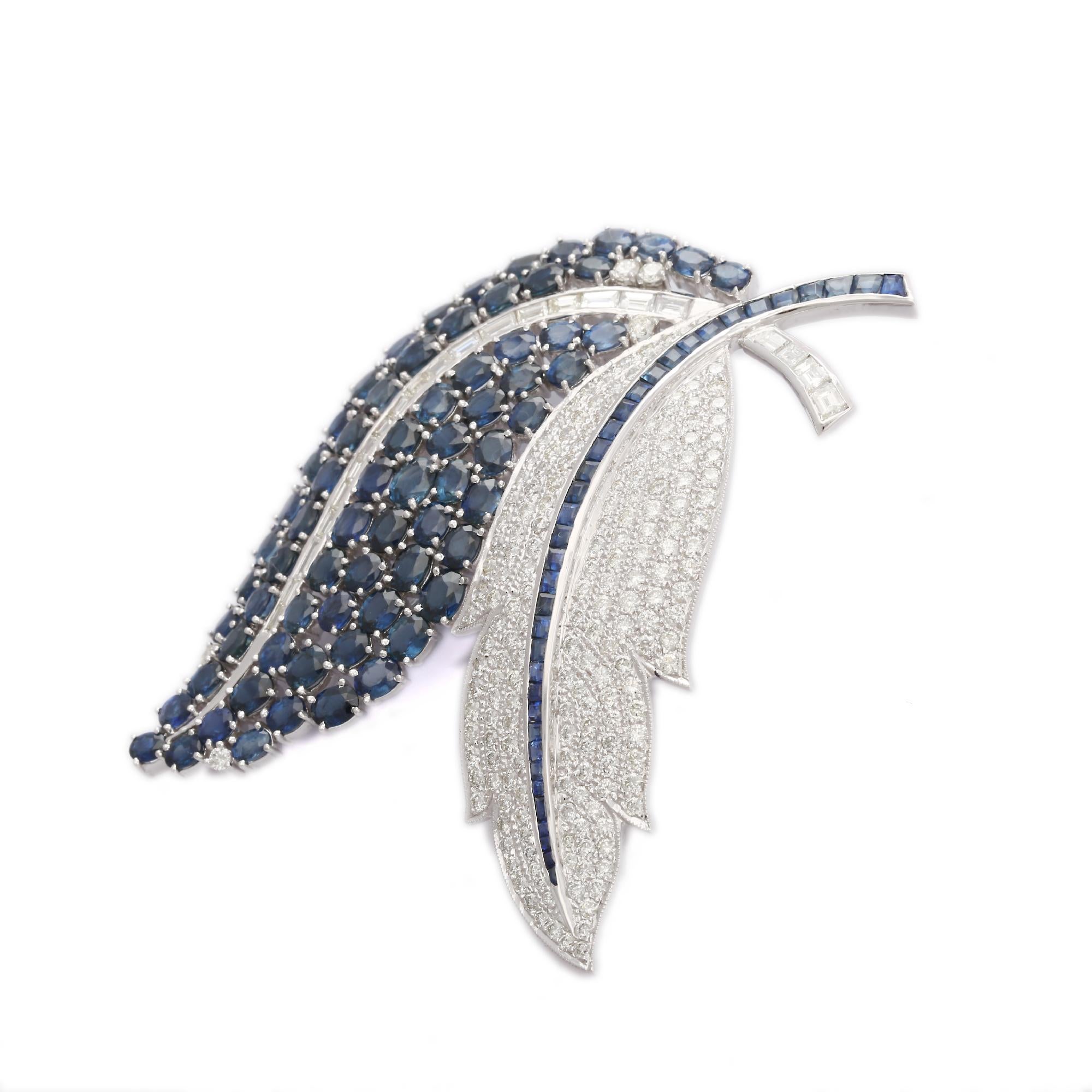 Blue Sapphire and Diamond Feather Brooch Made in 18K Gold which is a fusion of surrealism and pop-art, designed to make a bold statement. Crafted with love and attention to detail, this features 23.97 carats of blue sapphire which makes you stand