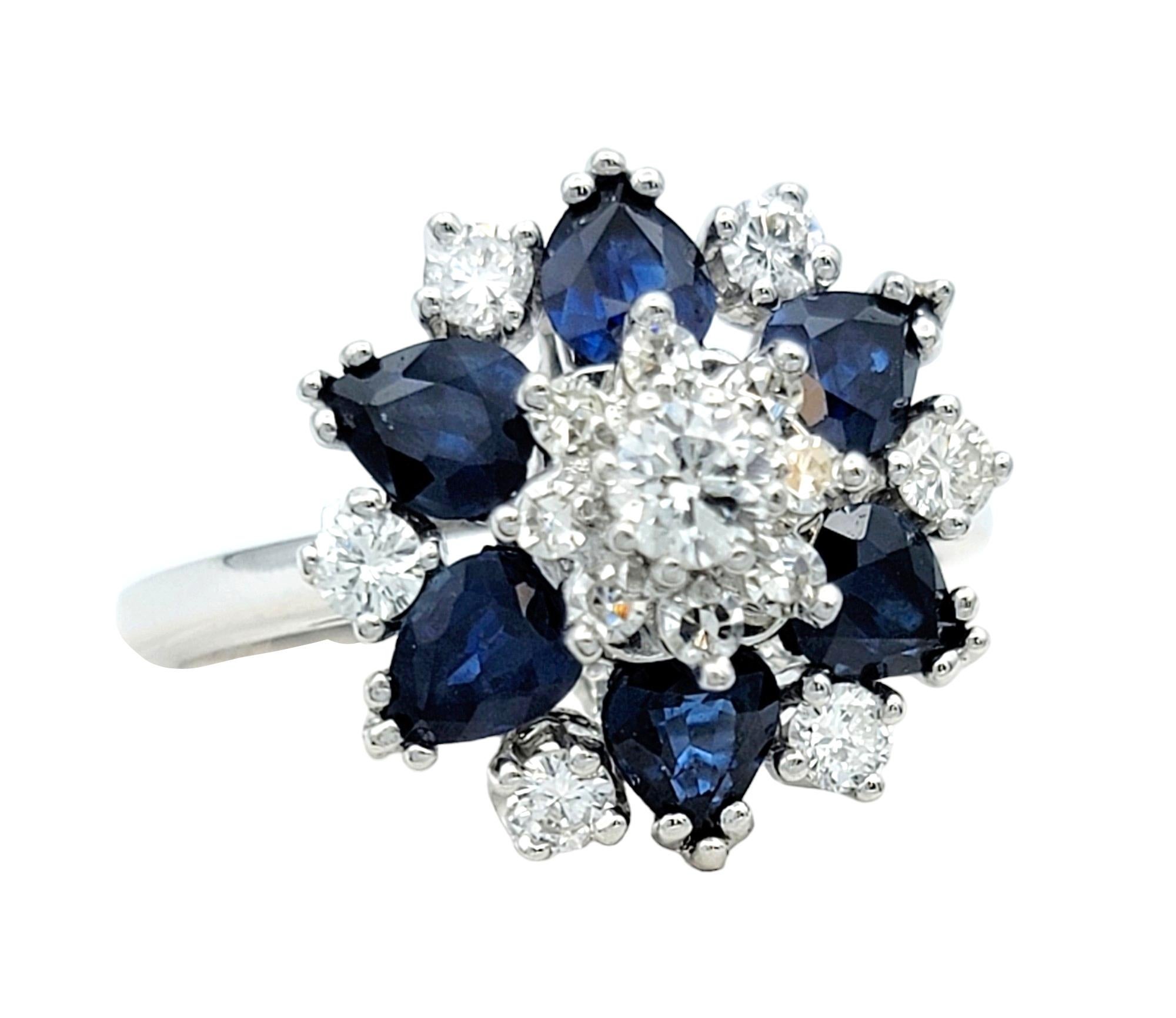 Ring Size: 8.75 

This stunning sapphire and diamond ring, set in luxurious 14 karat white gold, is an elegant a flower motif that is a beautiful addition to any ensemble. The central diamonds serve as the focal point, surrounded by pear-cut