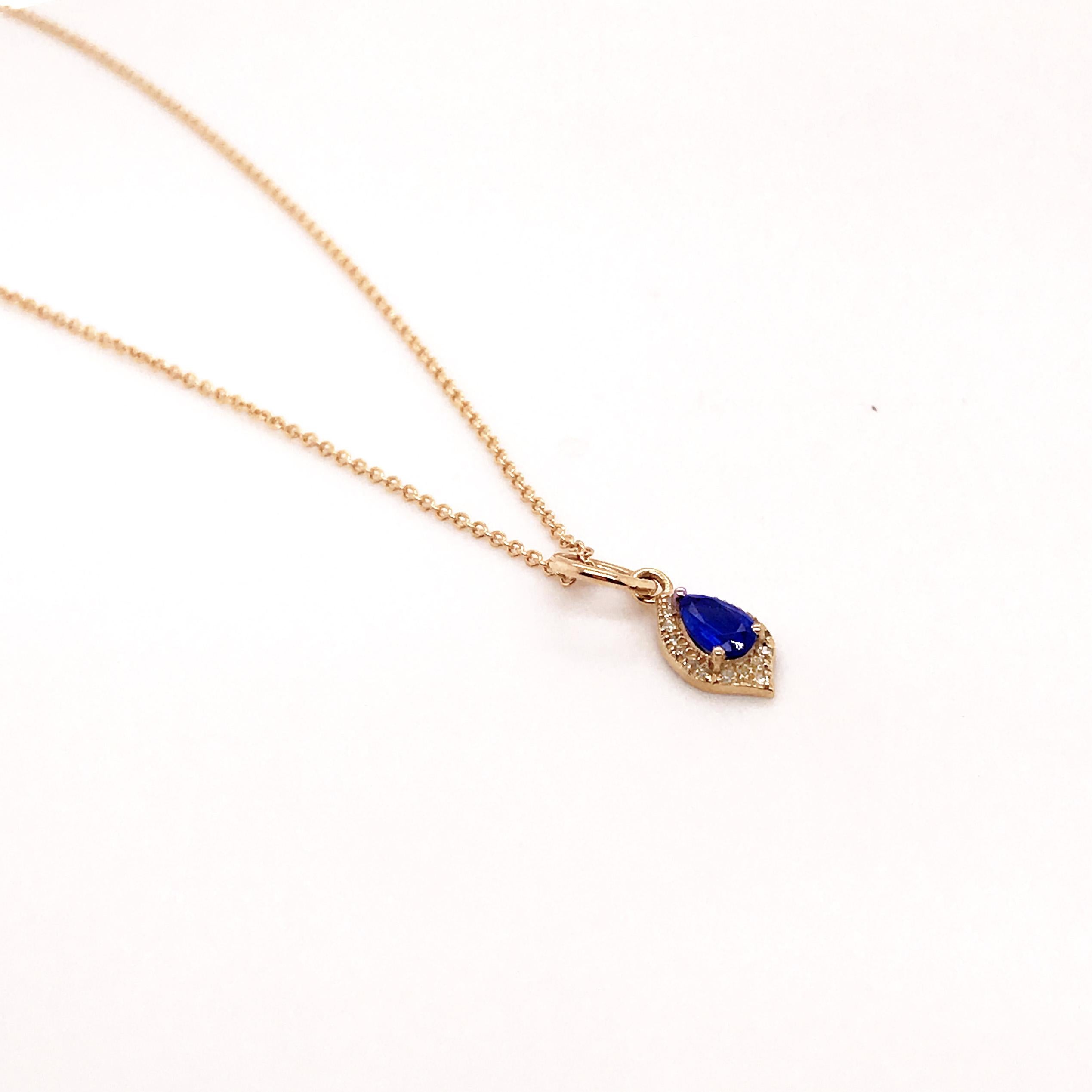This minimalist pendant has a fantastic pear shaped sapphire with a halo of diamonds around it. all set in 14 karat yellow gold.  The 14k gold looks amazing with the contrast of the blue sapphire.  The diamonds and sapphire are excellent quality