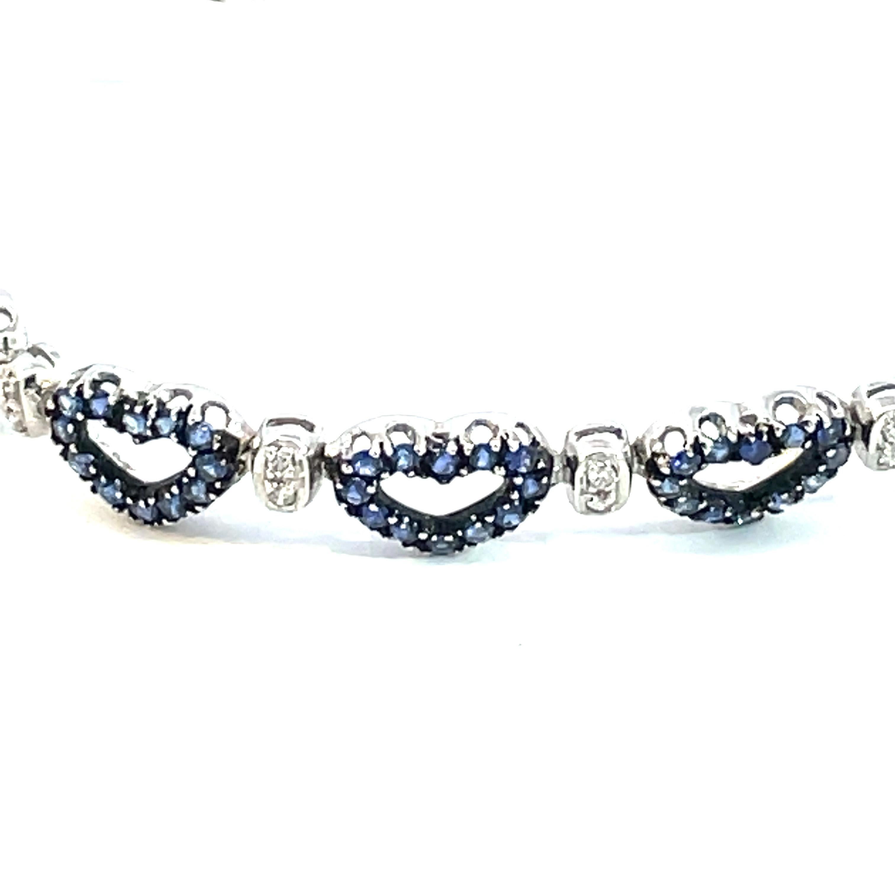 One 18kt white gold hearts shape bracelet with natural blue sapphires and brilliant cut diamonds with a black rhodium finish around the blue sapphires.  Perfect for everyday with a little splash of love. 

168 natural blue sapphires weighing 3.51ct
