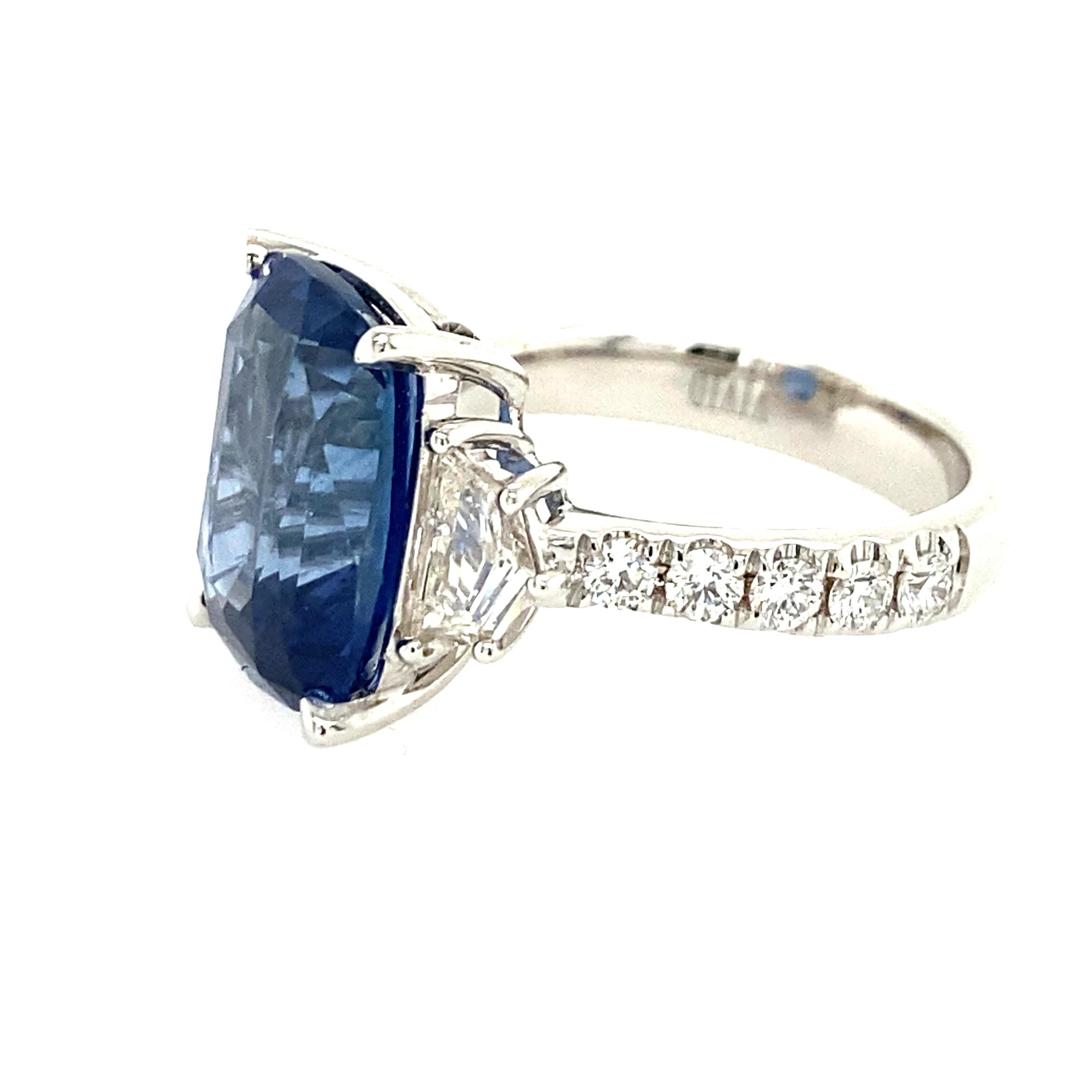 Fabulous cushion cut blue sapphire ring. The sapphire weighs 9.11carats and is GIA certified natural Ceylon (Sri Lanka) Sapphire. The sapphire measures 13.51x10.24x6.70mm. There are two shield cut diamonds on either side that weigh a total of