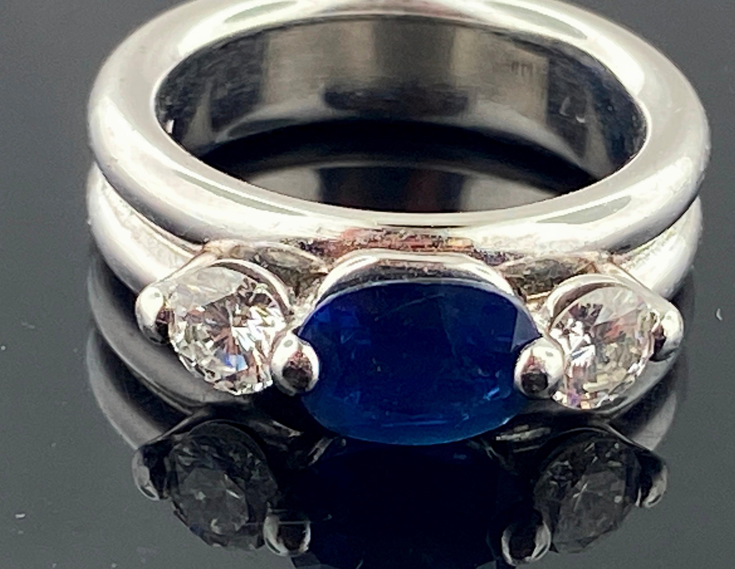 Set in Platinum is a 1.61 carat center blue sapphire with 2 round brilliant cut diamonds on the side with a total diamond weight of 0.70 carats.  Color is G, Clarity is VS.  17 grams.  Ring size is 6.