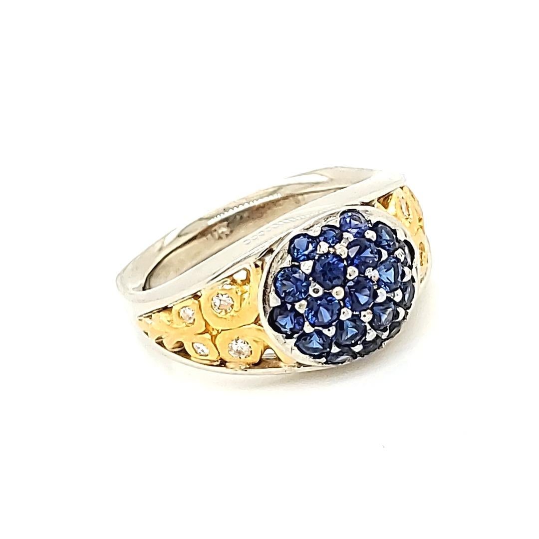 Blue Sapphire and Diamond Ring with 18 and 24 K gold work.

A scintillating bevy of round blue Sapphires adorns the top of this well fashioned ring in between which white prongs are purposely set prominently to show a contrast against the