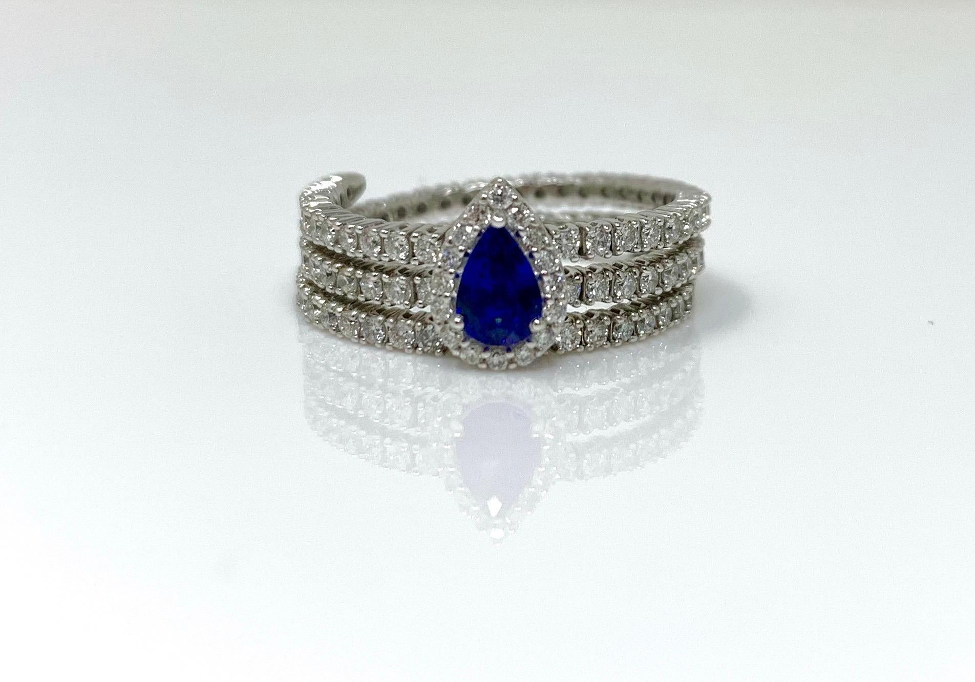 MOGULDIAM INC blue sapphire and diamond flexible ring set in 14 k white gold. This ring doesn't have ring size it can fit any finger size. video can be shared upon request. 
The details are as follows : 
Blue sapphire : 0.47 carat 
White diamond :