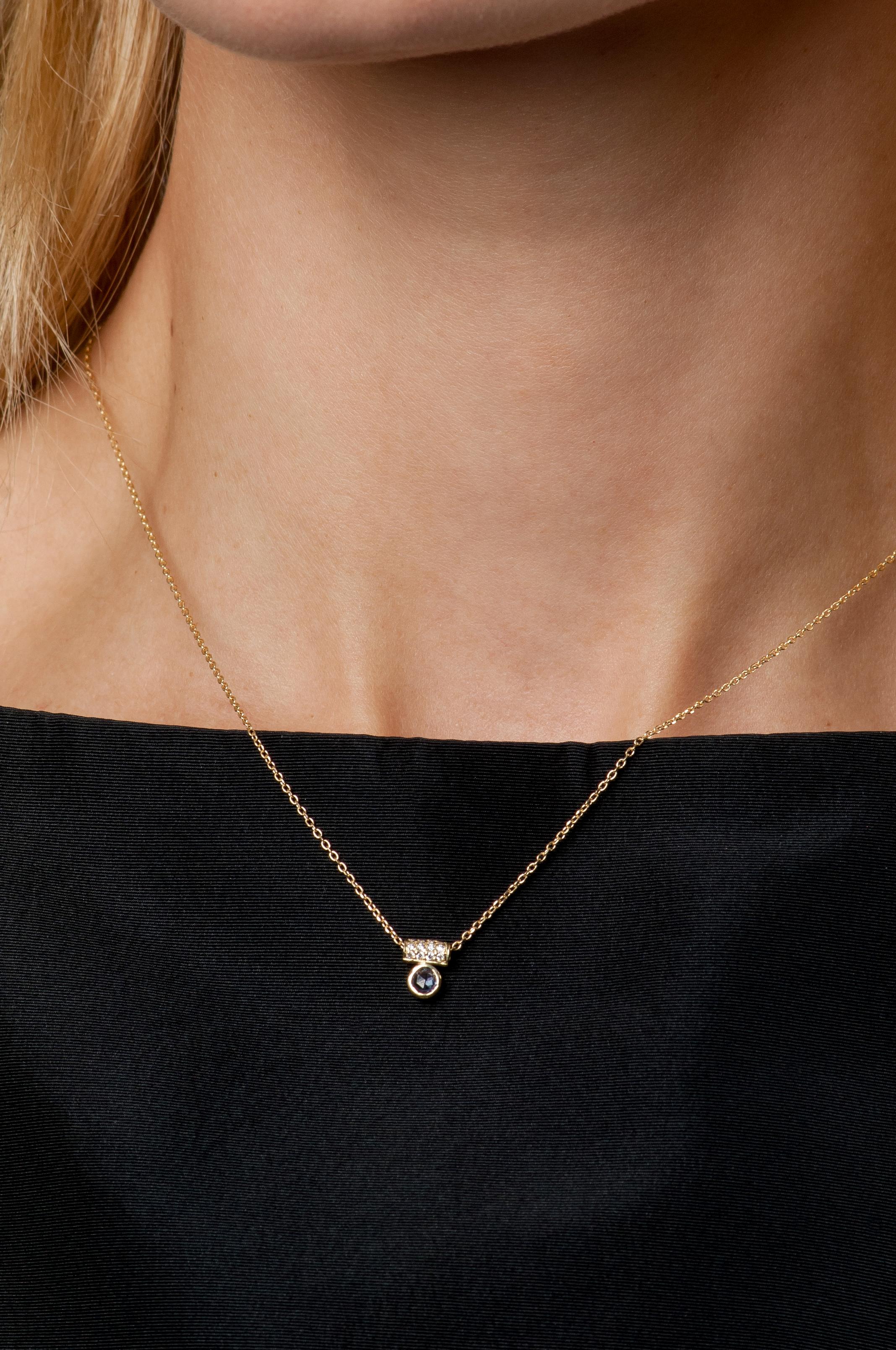 A rose cut blue sapphire floats below a diamond encrusted tube on this delicate necklace. Perfect for layering with other favorite pieces.

18K yellow gold chain with 0.14 inch bezel set blue sapphire
Pave set diamond tube pendant totaling 0.06