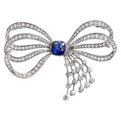 Vintage Blue Sapphire and Old Mine Cut Diamond Platinum Bow Spray Brooch, circa 1930s