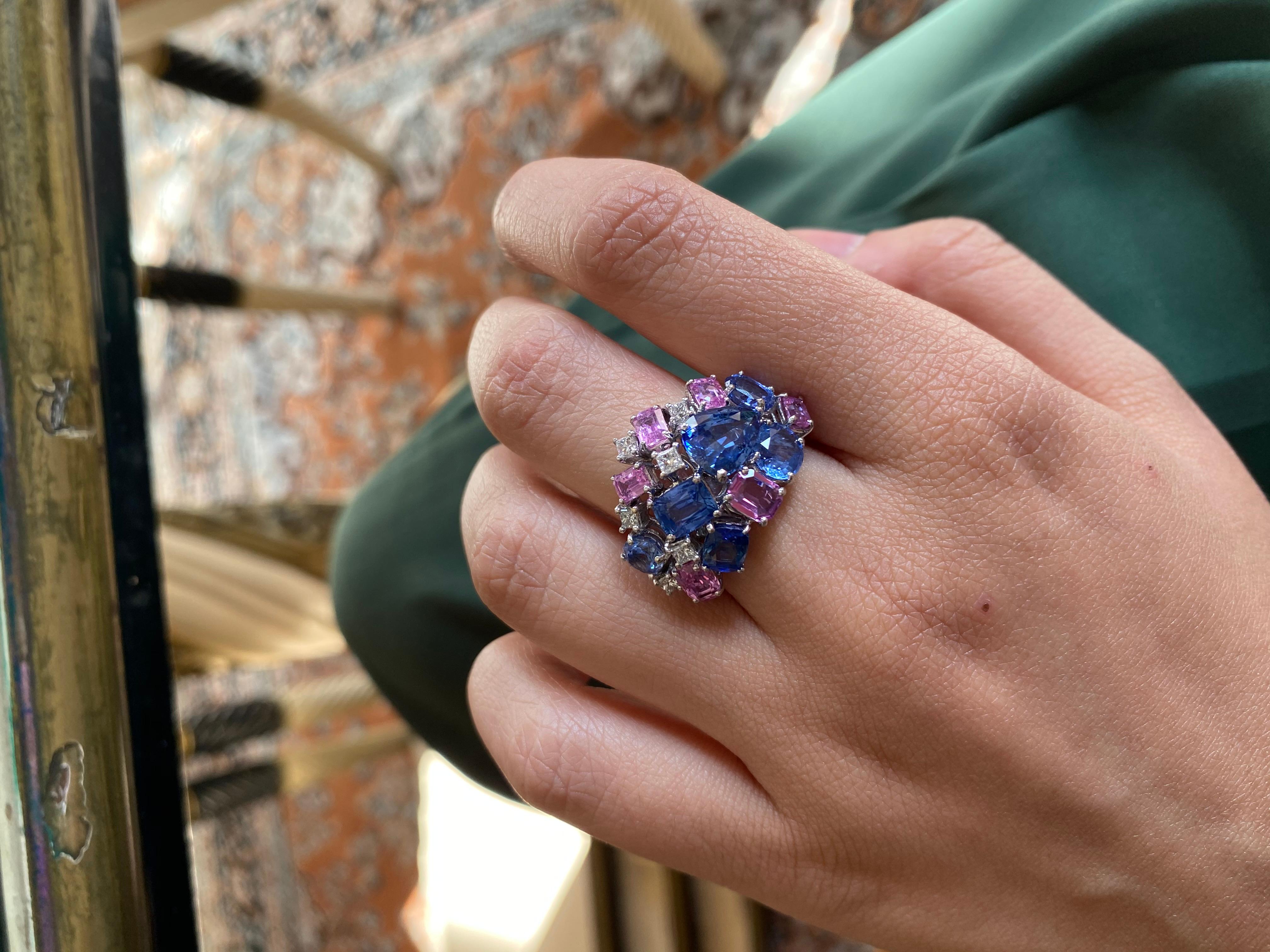 A beautiful and modern band style ring set with blue and pink sapphires in 18 karat white gold . The blue sapphire weight is 6.43 carats and pink sapphire weight is 2.24 carats . Diamond weight is .36 carats and net gold weight is 10.815 grams. The