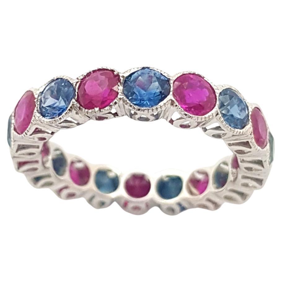 Blue Sapphire and Ruby Eternity Ring set in 18K White Gold Settings For Sale