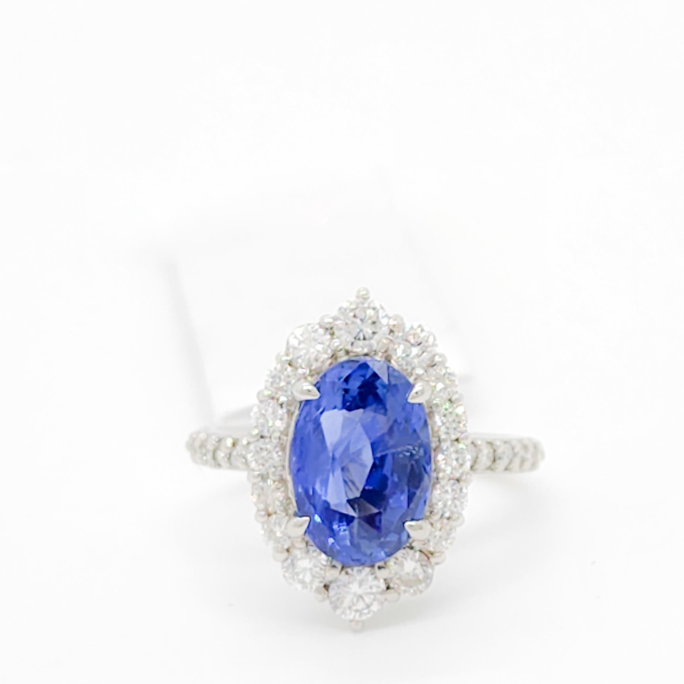 Gorgeous 3.88 ct. blue sapphire oval with 0.80 ct. good quality white diamond rounds.  Handmade in platinum.  Ring size 5.75.