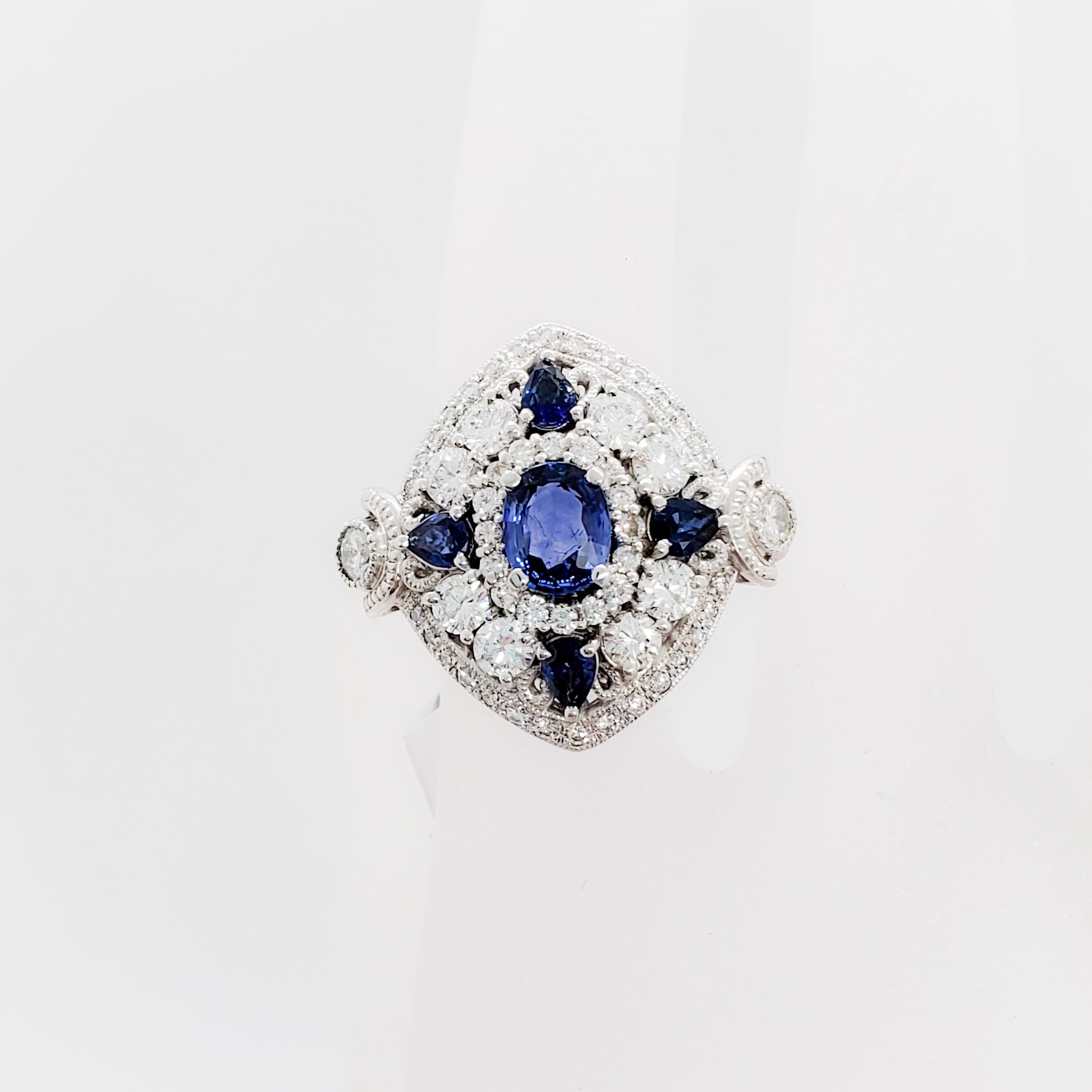 Gorgeous blue sapphire oval and pear shapes with dark blue color and good crystal weighing 2.43 carats.  1.02 carats of good quality white diamonds in a 18k white gold mounting.  Ring size 5.75.  