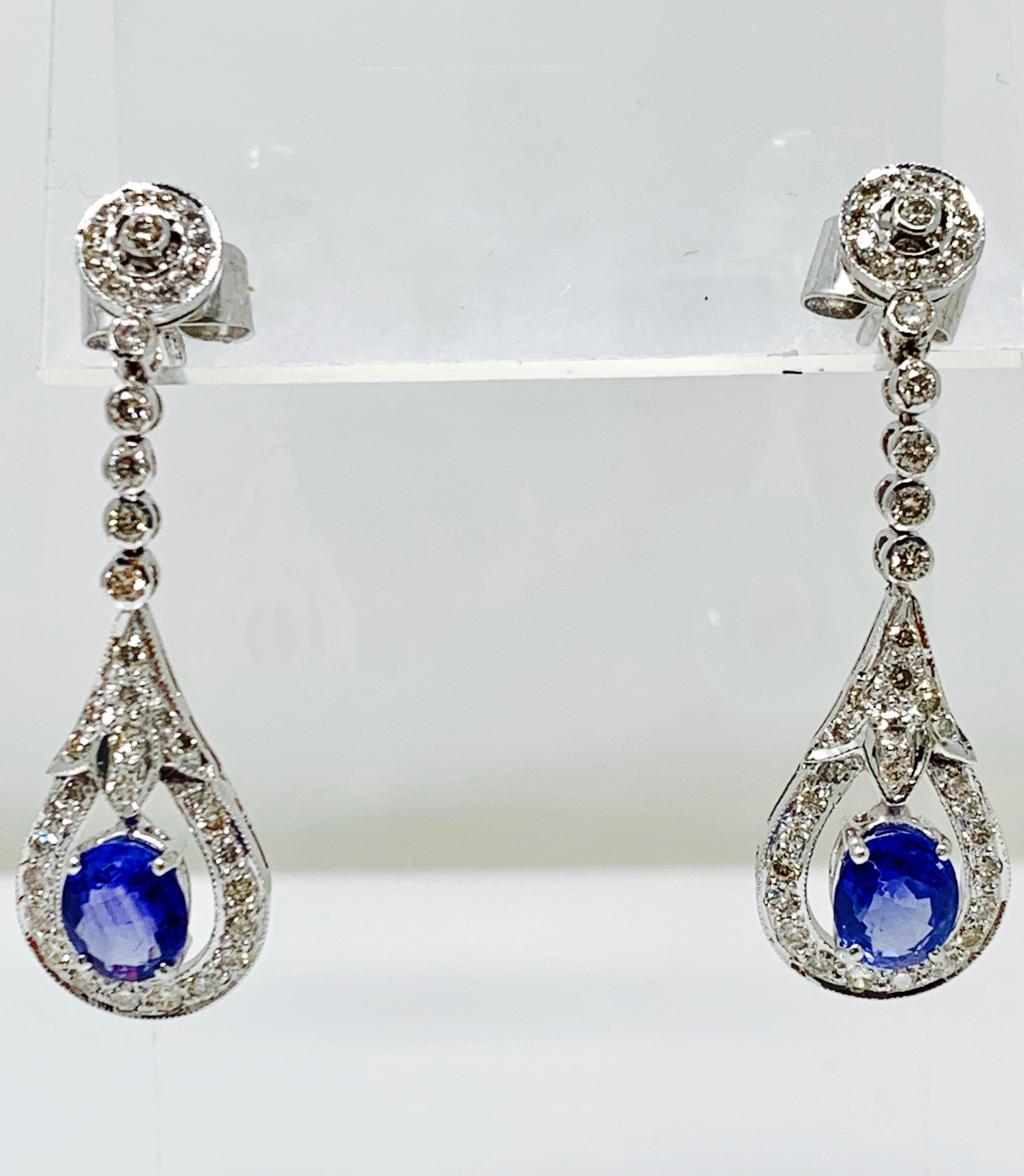 Moguldiam Inc Blue Sapphire and diamond earrings custom handmade in 14k white gold. 
 Blue sapphire weight : 3.40 carat 
Diamond weight : 1.50 carat 
Gold weight : 7.5 grams 
Metal : 14 k white gold. 