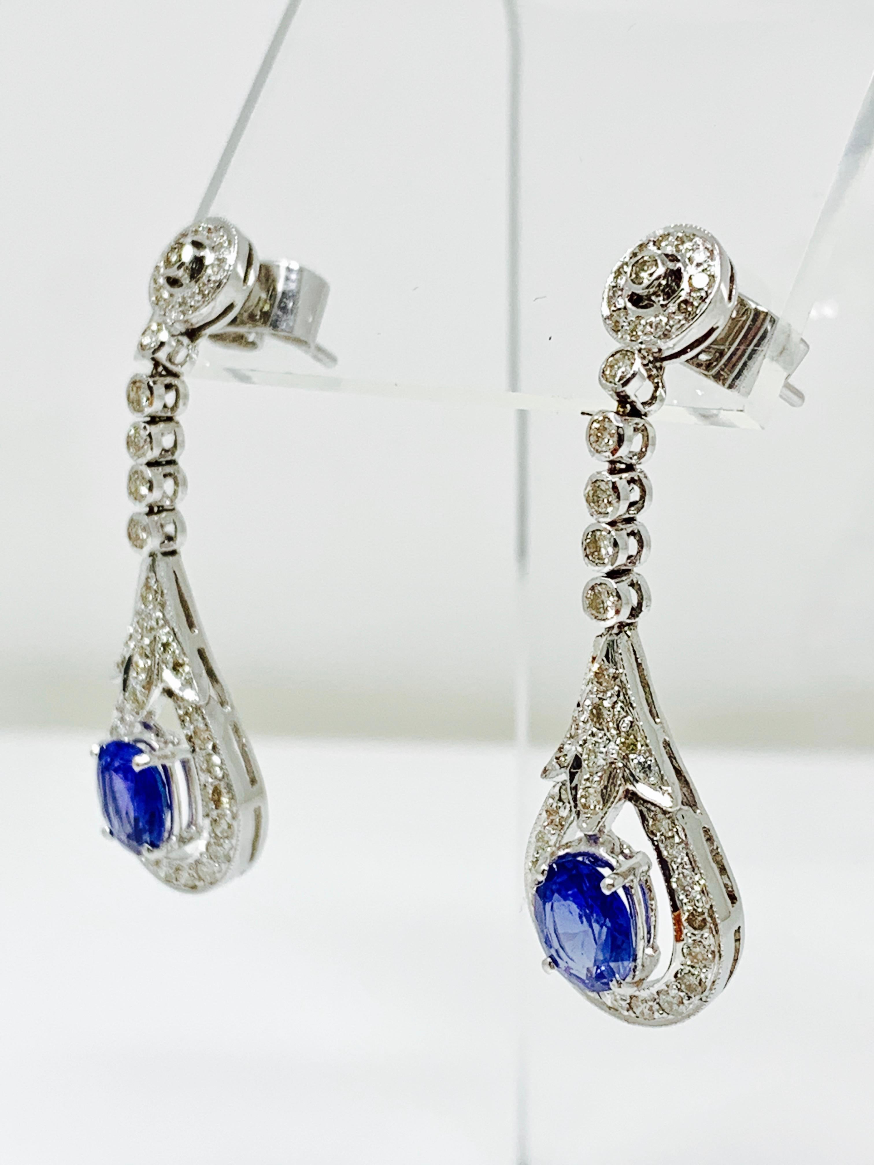 Contemporary Blue Sapphire and White Diamond Dangle Earrings in 14 Karat Gold For Sale