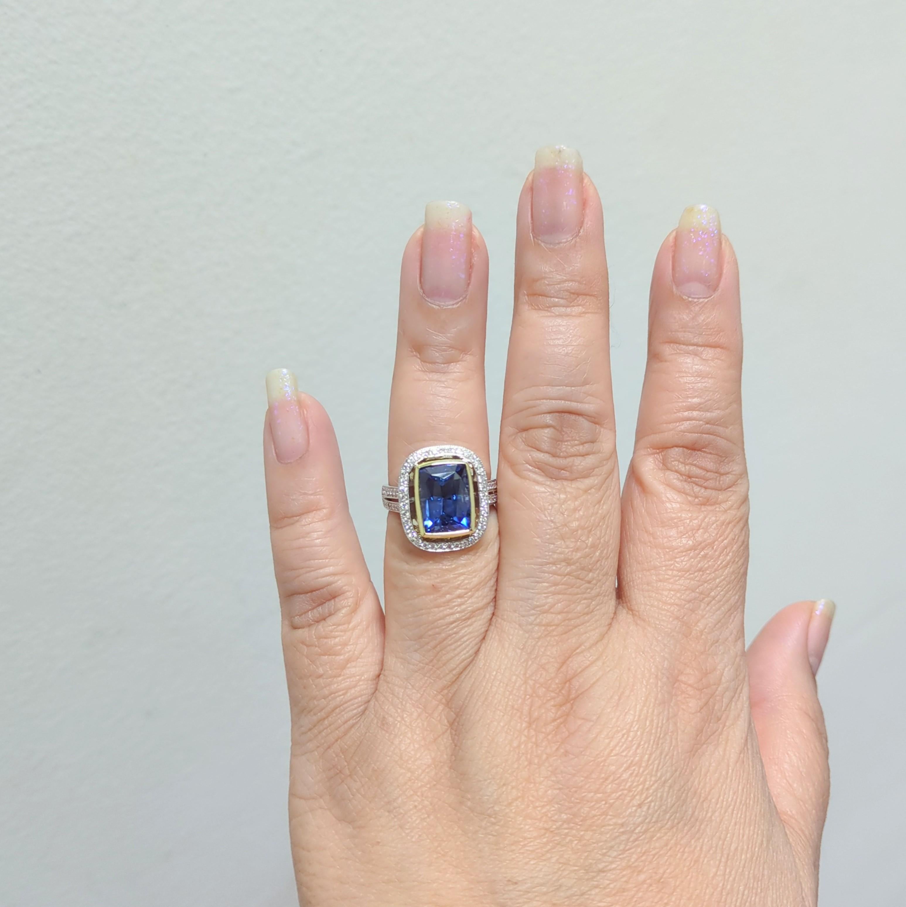 Gorgeous bright blue sapphire weighing 6.80 ct. with good quality, white, and bright diamond rounds.  Handmade in platinum and 18k yellow gold.  Ring size 7.5