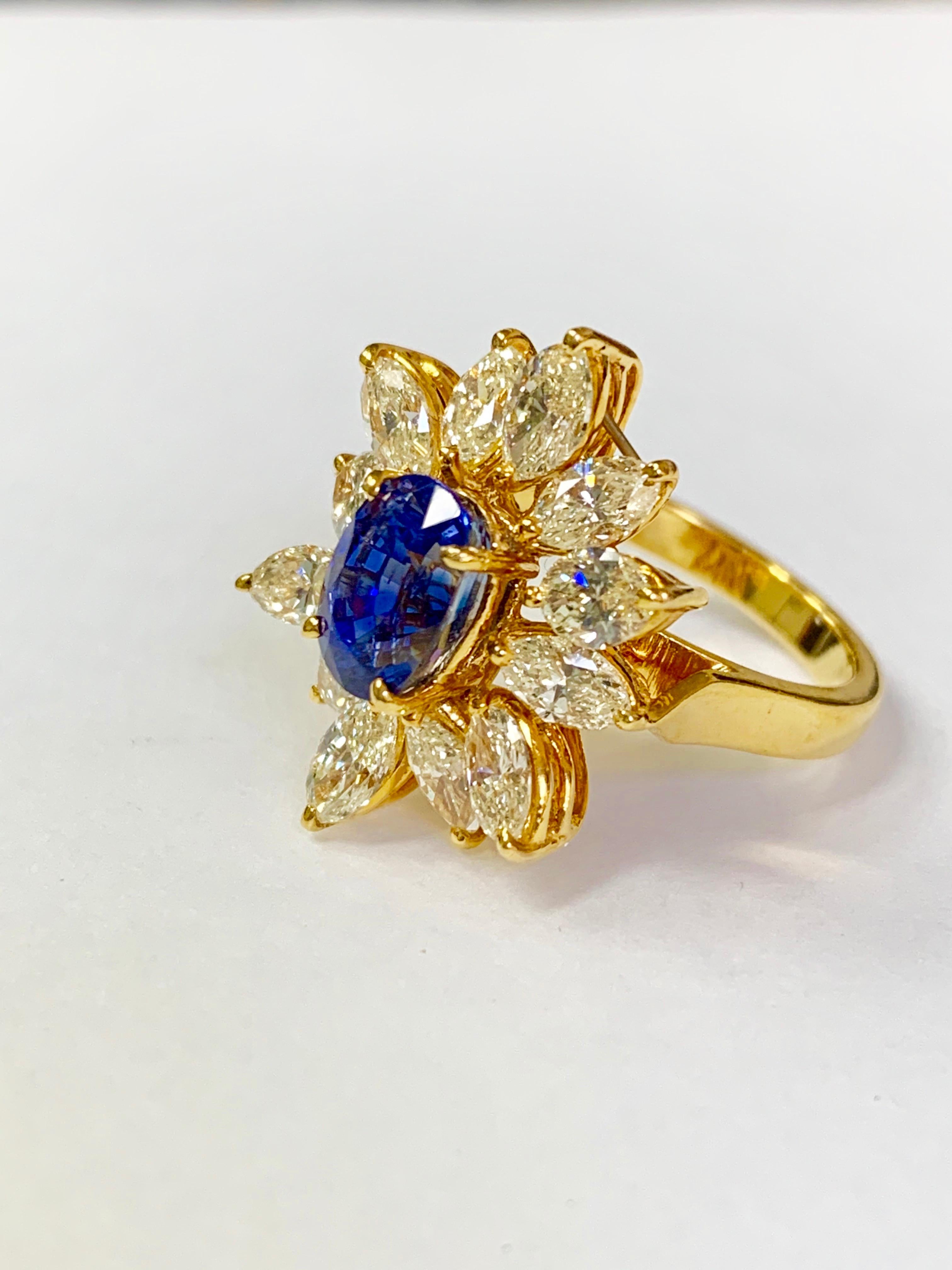 Oval Cut Blue Sapphire and Yellow Diamond Ring in 18 Karat Yellow Gold For Sale