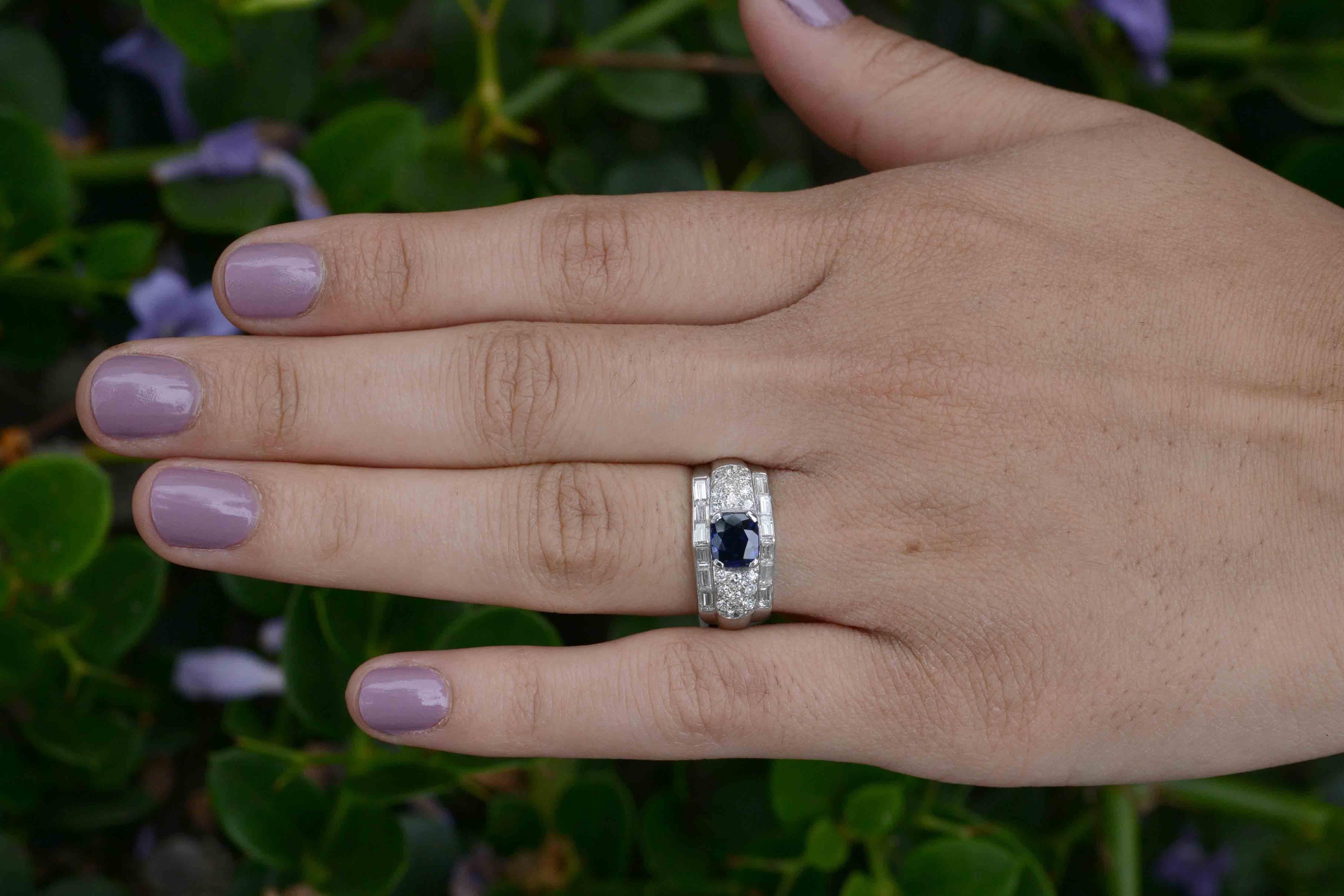 The sight of the ring will make her heart skip a beat; the lush blue of the sapphire and the glimmer of the baguette diamonds will make any woman swoon. Centered by an antique cushion cut Burma Sapphire of 1.25 Cts., set as a pyramid nestled in a