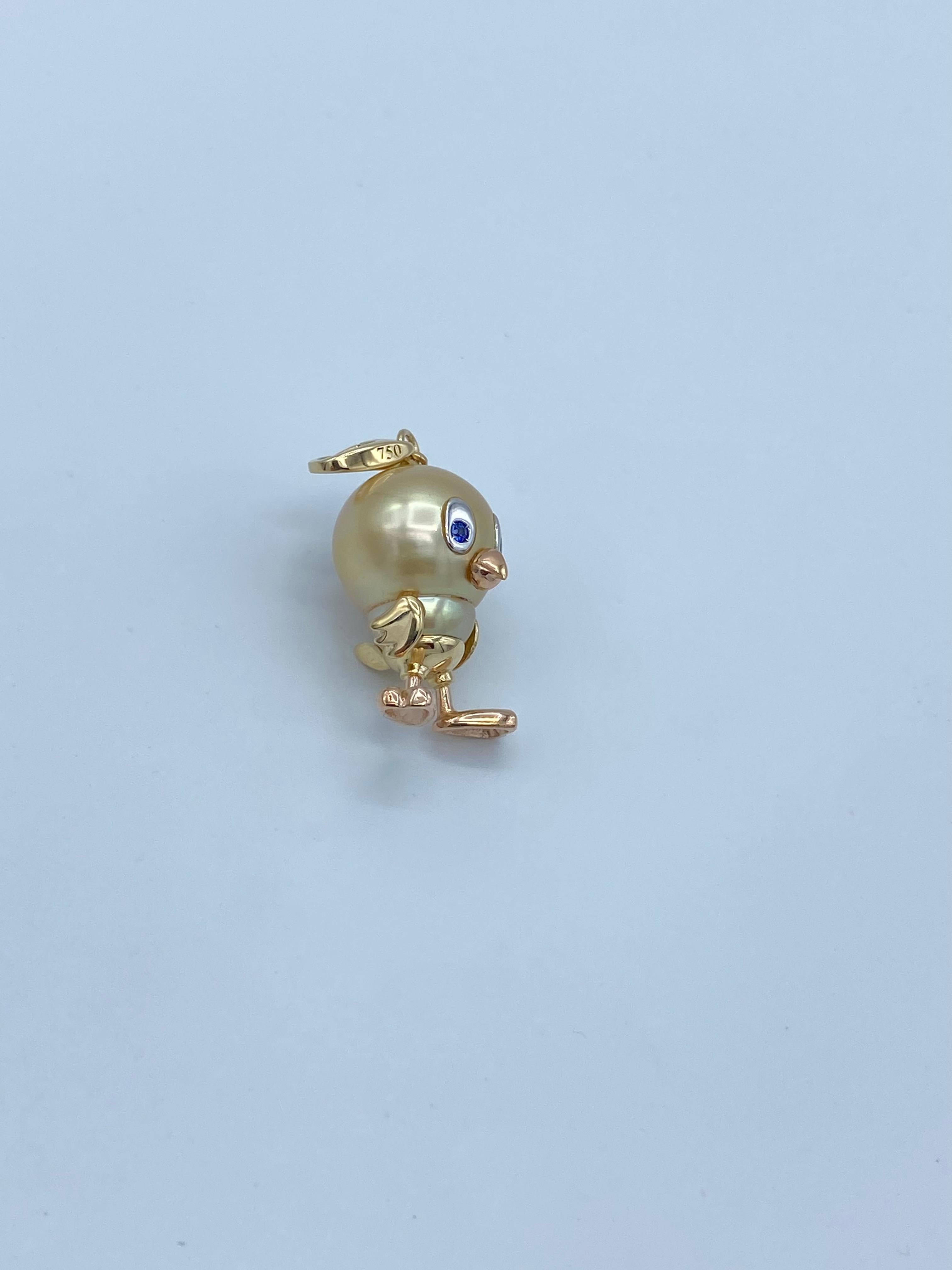 This pendant is made as if it were a caricature of a little bird, looks like Tweety.
The very beautiful Australian pearl is 16x14 mm.
The eyes set on white gold, are blue sapphires.
The legs and the beak are in pink gold, the other elements are in