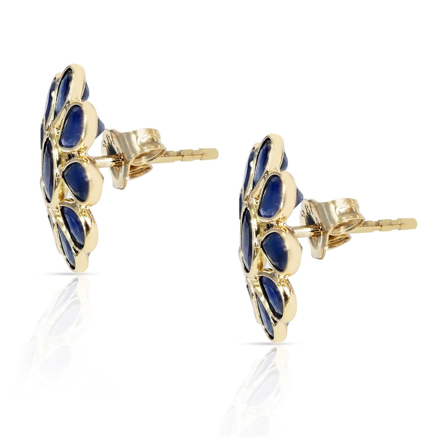 A pair of Blue Sapphire Bezel-Set Oval and Pear Shape Floral Earrings made in 18 Karat Yellow Gold. The design of the earring is inward. The stone weight is 0.86 carats, and the total weight of the earrings is 2.02 grams. There is one oval stone and