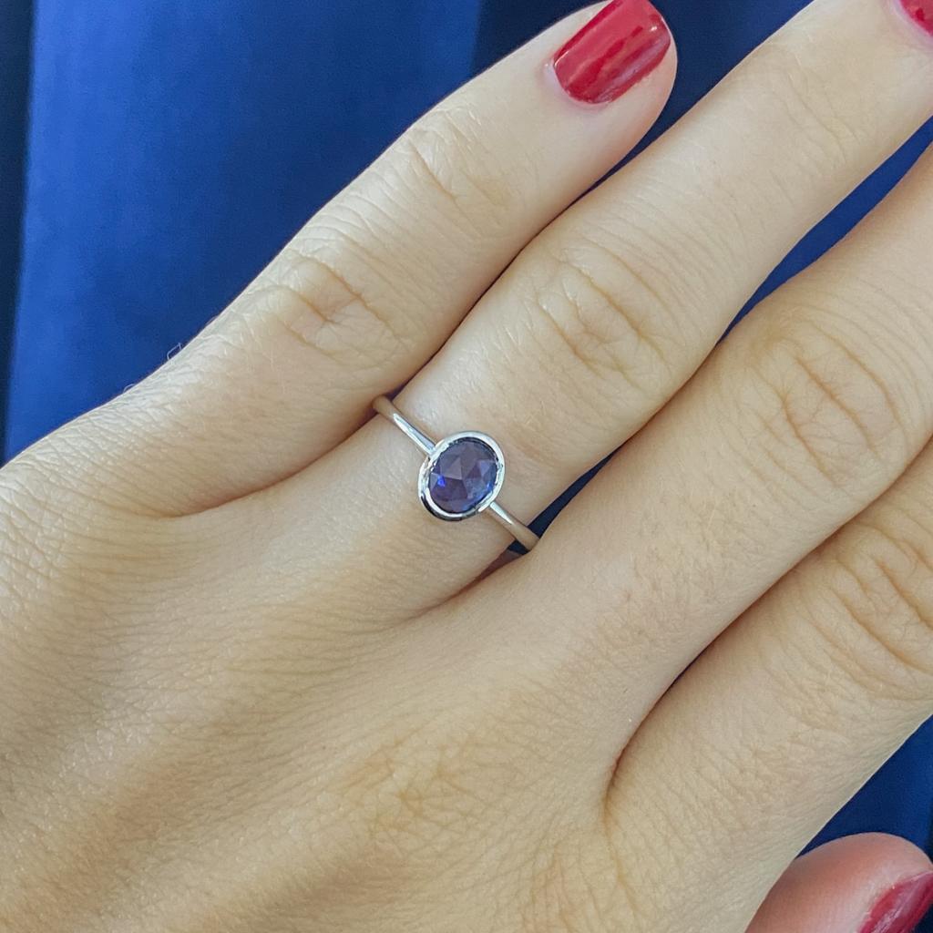 This sapphire ring has lovely smooth curves in a one-of-a-kind piece. The rose-cut oval sapphire is set in a custom bezel to fit its own unique shape. Any similar piece will never be exactly like it. This ring was handmade and is from Austin's