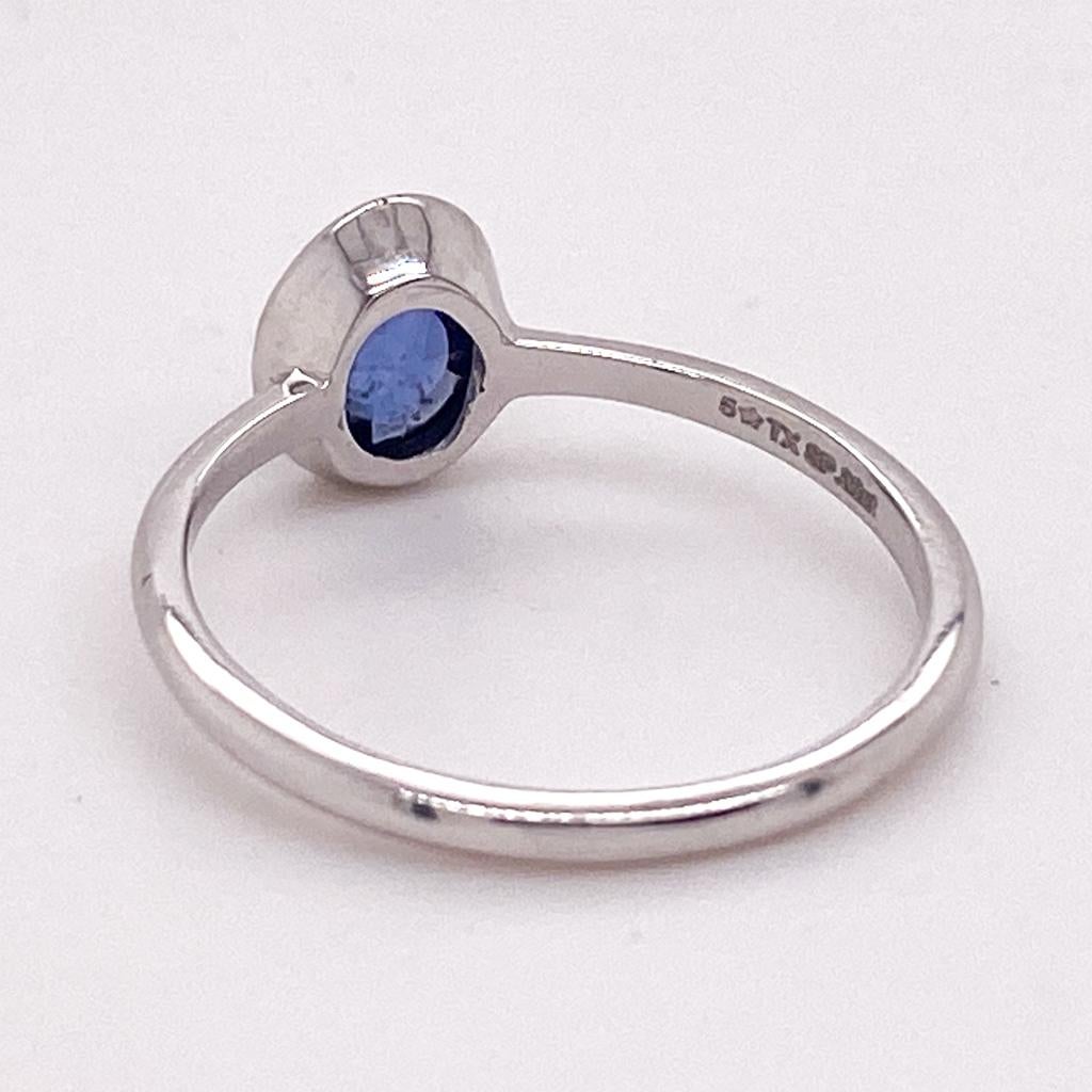 Oval Cut Blue Sapphire Bezel Solitaire Ring 0.82 Carats in 14k White Gold For Sale