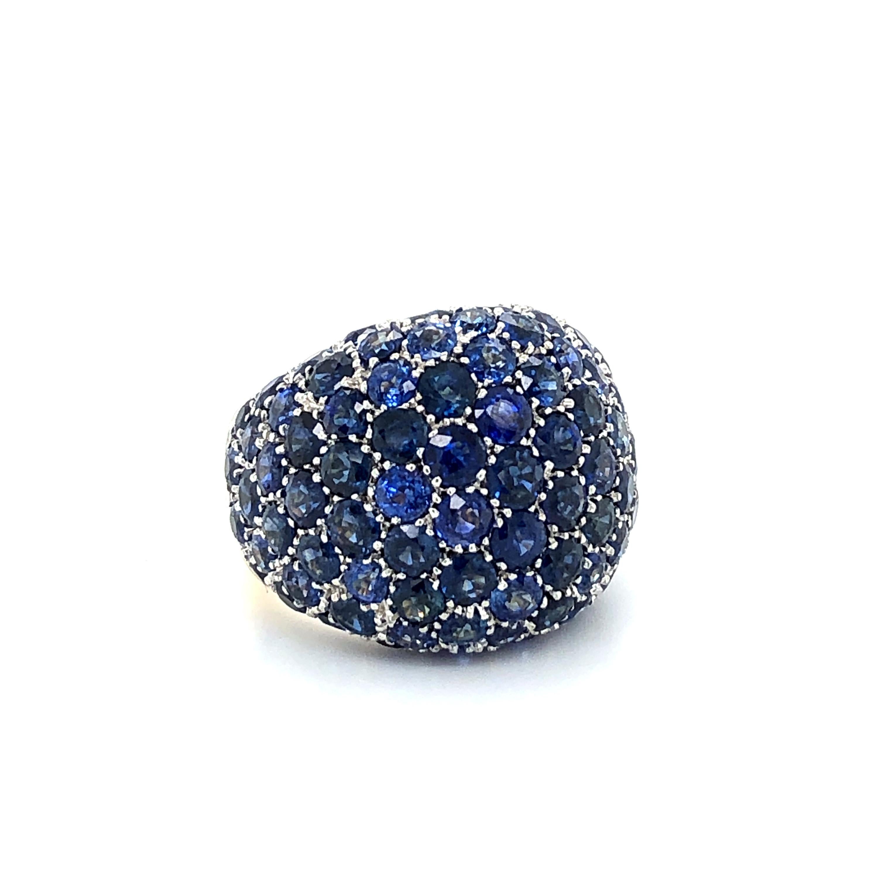 This striking big blue bombé bauble, dating back to the 1970's, features a large glittering dome composed of 95 pavé-set brilliant-cut sapphires totalling approximate 9.50 carats. 

The coning, high polished ring shank is finished with 