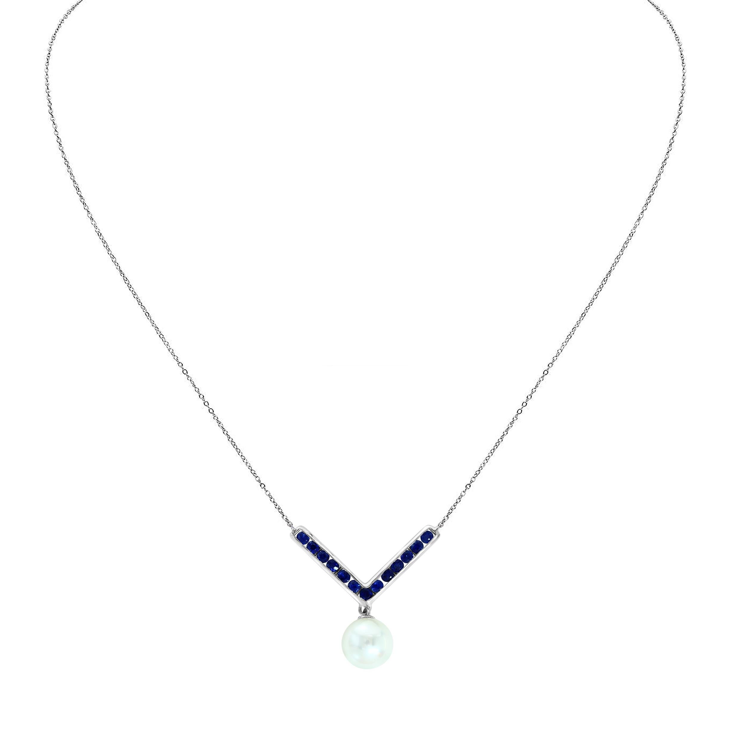 This popular style features a round Freshwater white pearl measuring 7-7.5mm dangling from a blue sapphire chevron style detail on a .925 Sterling Silver chain. This is a perfect necklace to layer or wear or its own. Enjoy this necklace as an