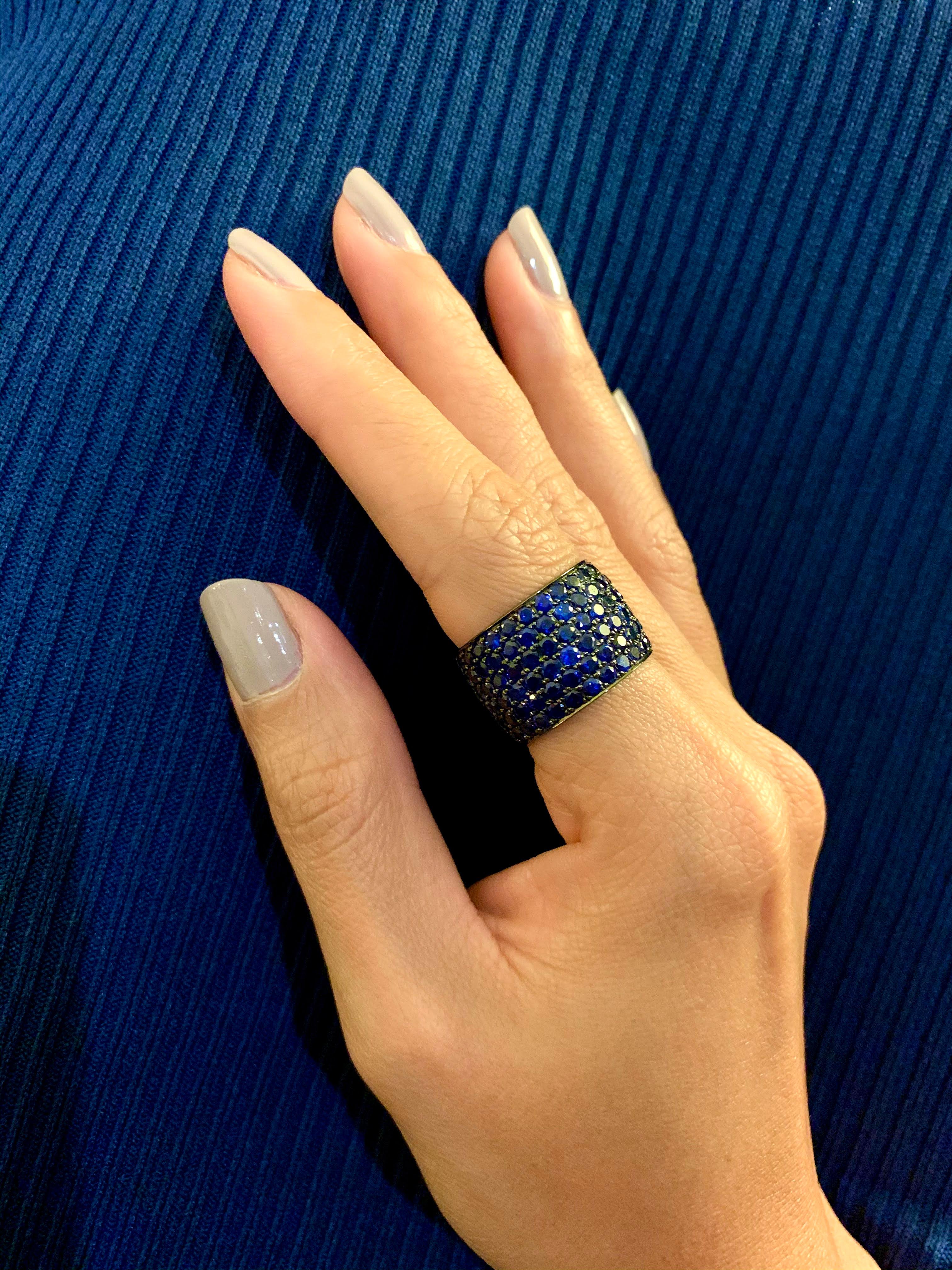 Deep blue natural sapphire ring. All around encrusted with sapphires (over 18 carat in total weight), crafted with blackened 18 karat gold. This ring is very minimalistic and works on all outfits and occasions, from your office to evening party to