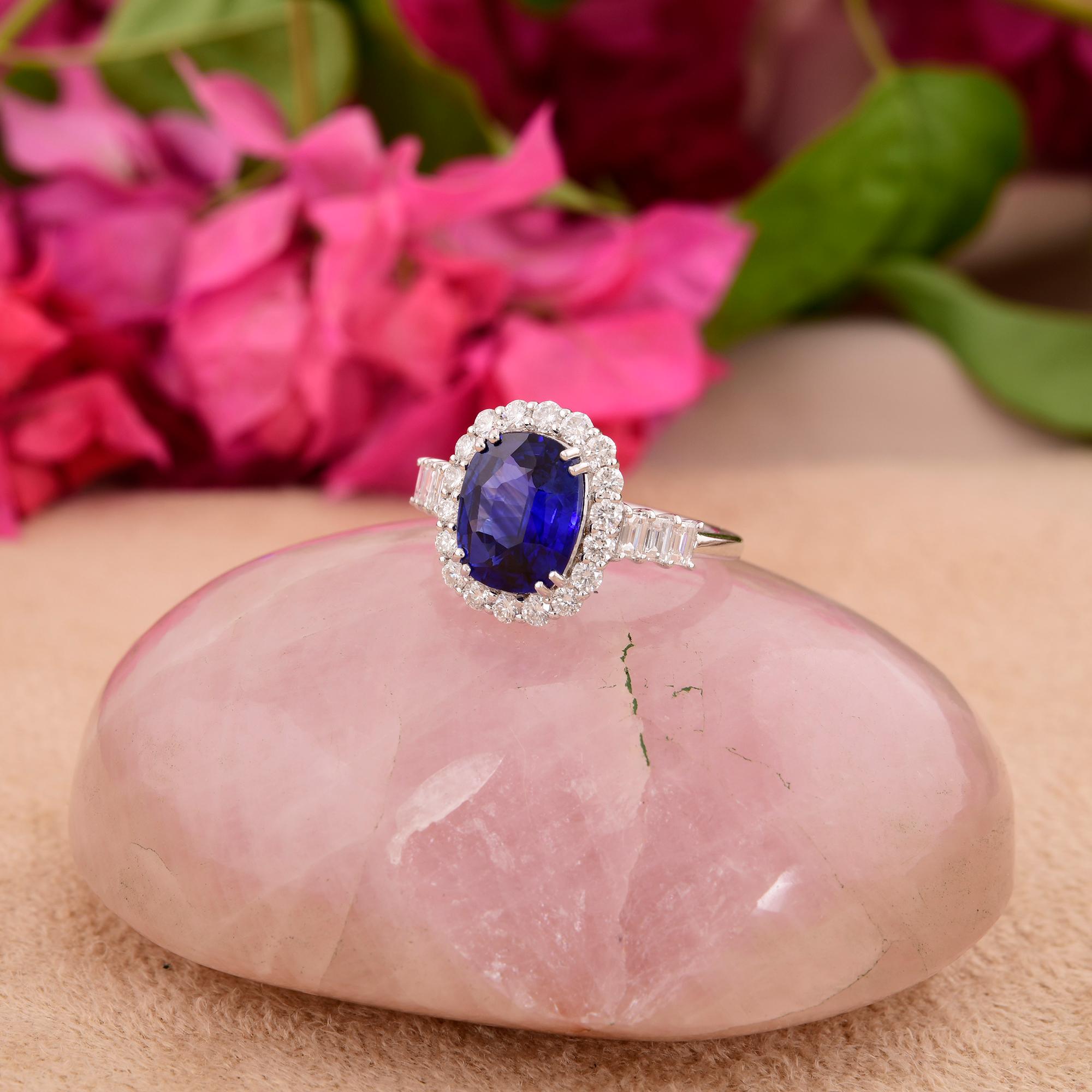At the center of the ring glistens a mesmerizing Blue Sapphire gemstone, renowned for its deep, captivating hue and unparalleled brilliance. The sapphire's rich color exudes a sense of regal allure and sophistication, making it the perfect