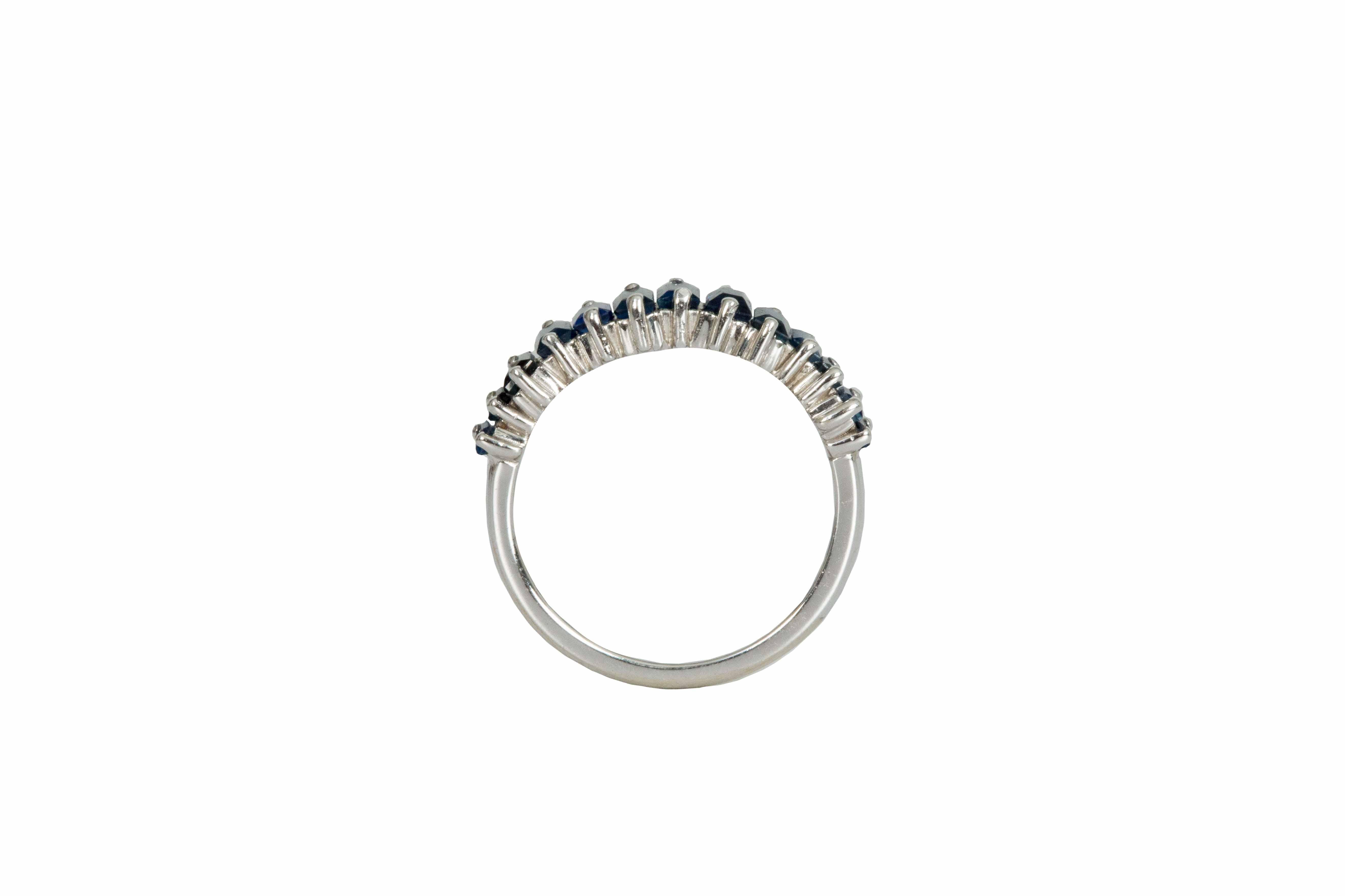 18 carat white gold band with 14 baguette cut natural sapphires weighing 1.70 carats total. Our sapphires are hand selected by our team of experts and carefully set unevenly to create a fascinating composition. A twist on tradition this 