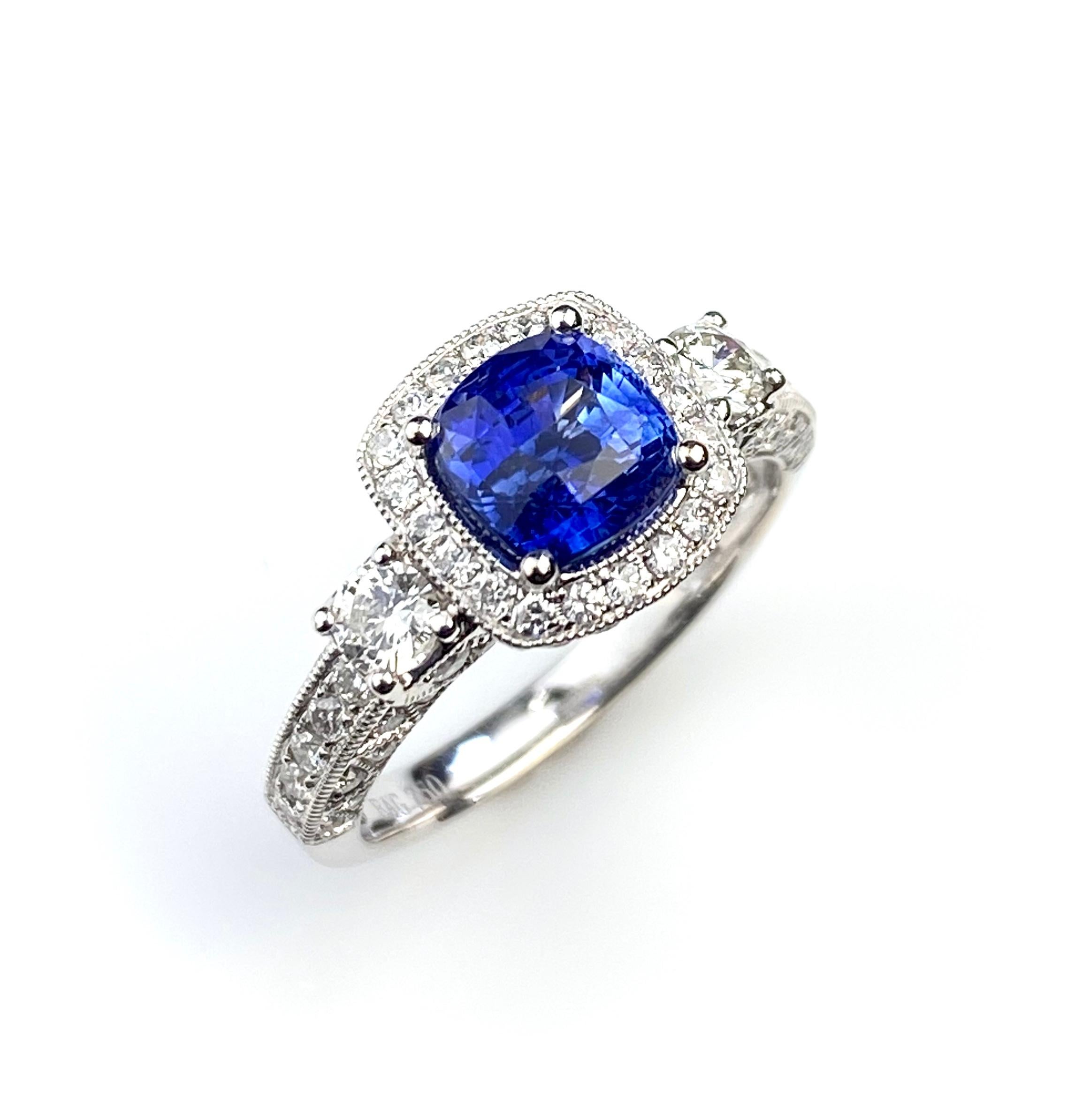 Cushion cut 1.78ct Blue Sapphire in an antique style 18kt white gold ring setting. Detailed with 0.73ct total of diamonds micro set around the centre gem and on the band. Current ring size 5 1/2. Complementary ring sizing up or down two sizes.