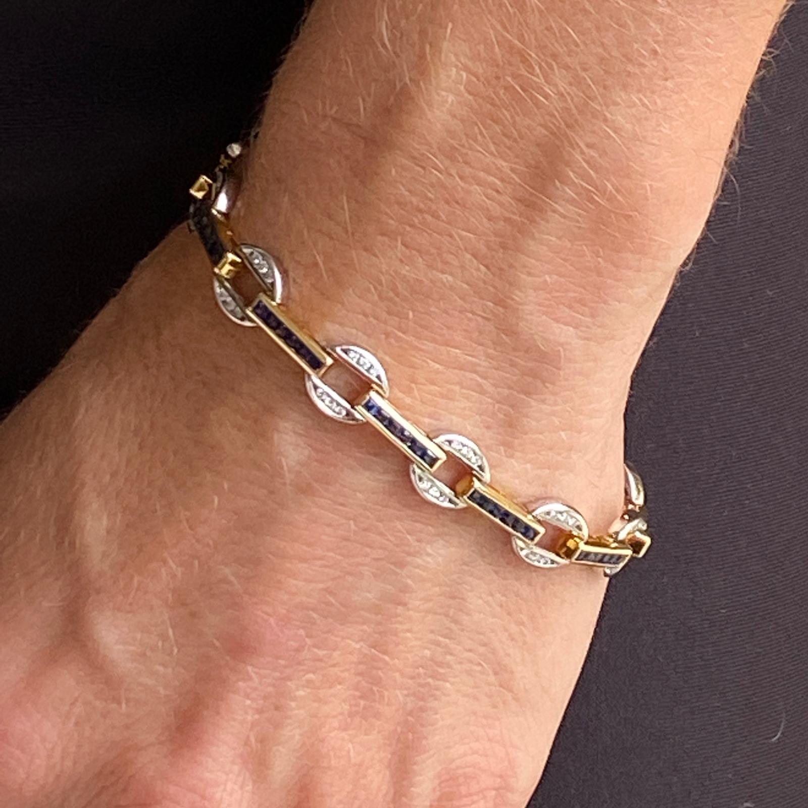 Beautiful sapphire and diamond bracelet fashioned in 14 karat white and yellow gold. The bracelet features round brilliant cut diamonds weighing 1.00 carat total weight and graded G-I color and VS clarity. The diamonds alternate with princess cut