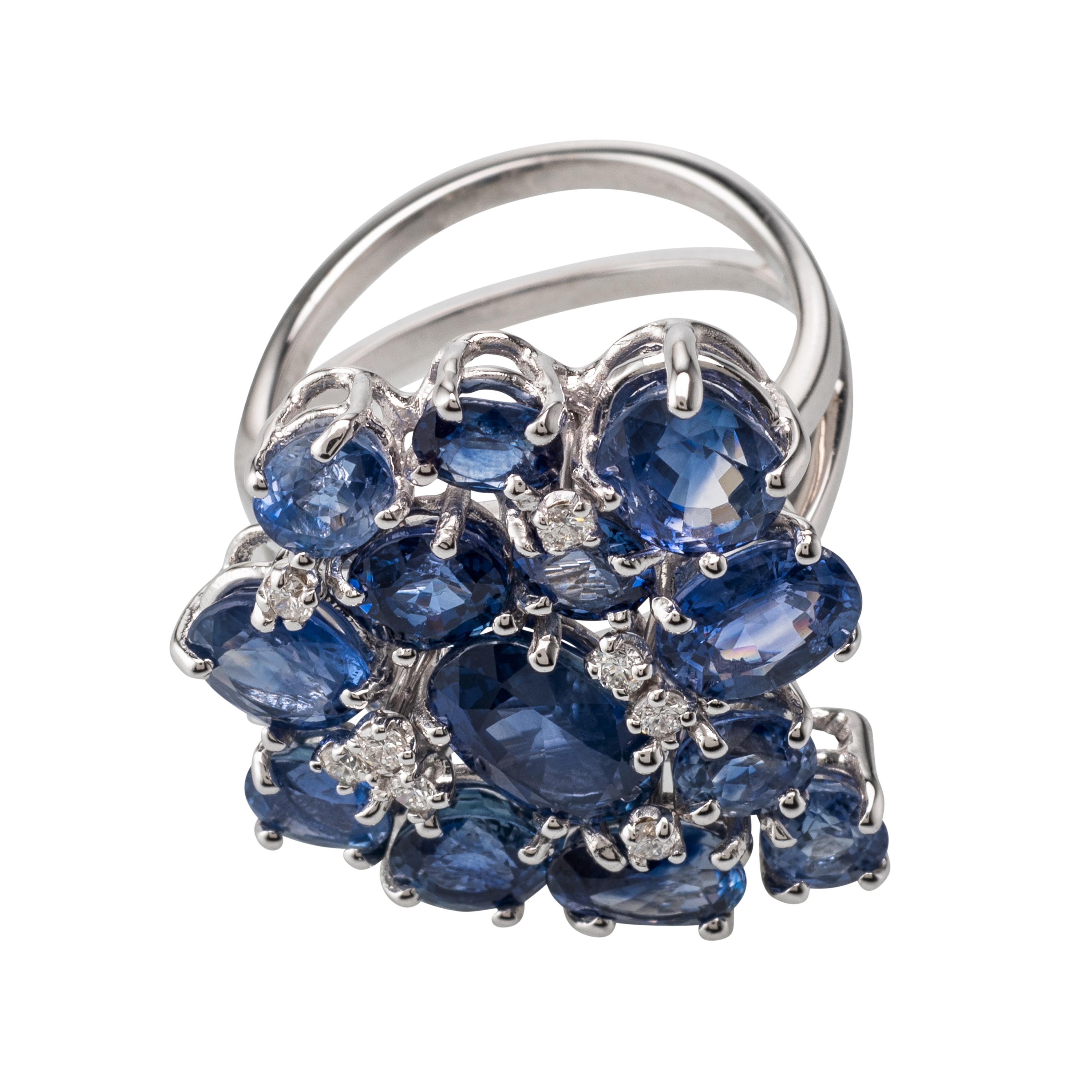 Multiple Blue Sapphire and Diamond set in 18 Karat White Gold.
Sapphire 10.42 Carats, Diamonds 0.18 Carats. This Ring is truly an impressive piece of jewellery. Produced in Italy, with attention to a very small detail.
Resizing can be done upon