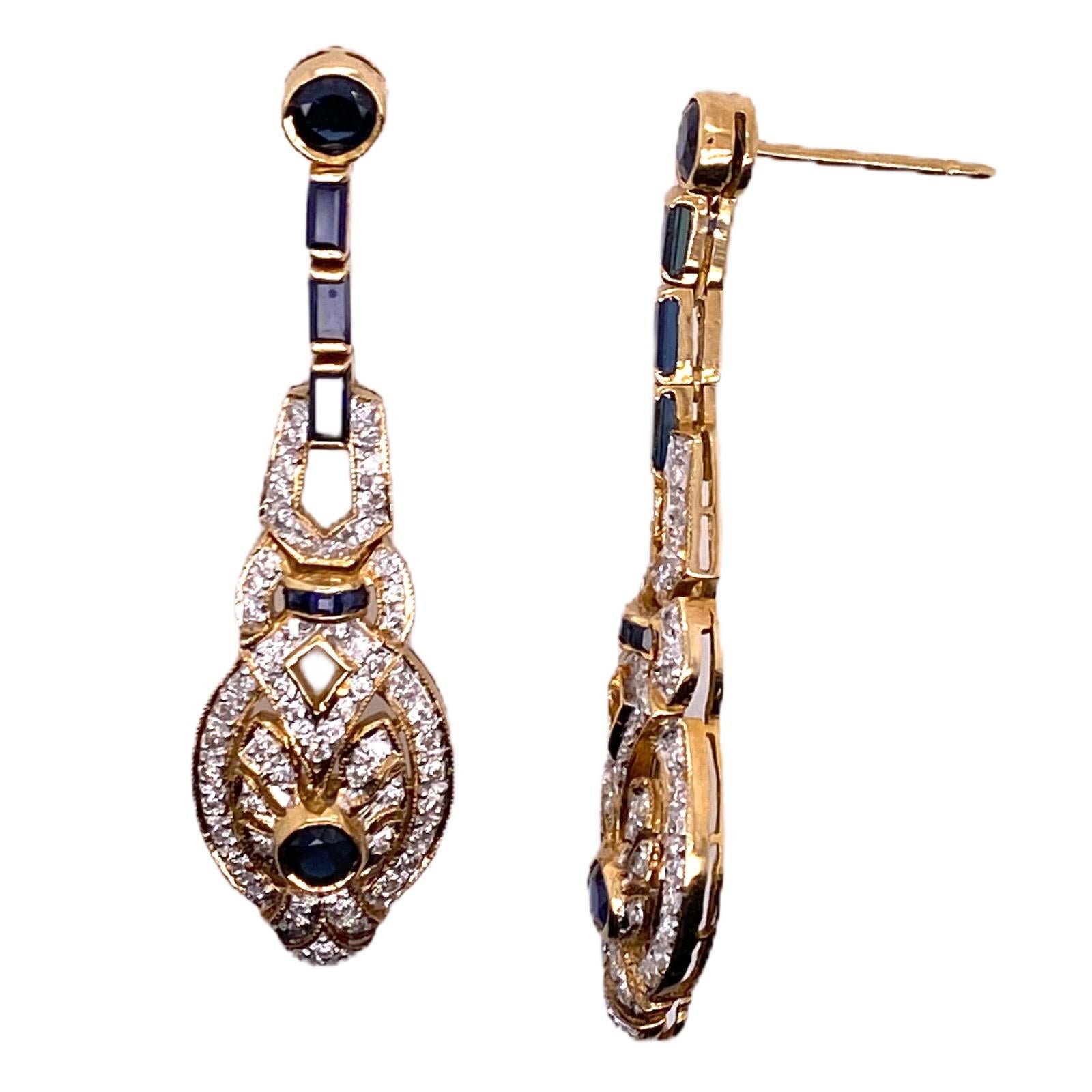 Gorgeous sapphire diamond drop earrings fashioned in 18 karat yellow gold. These estate earrings feature 124 single cut diamonds weighing approximately 1.00 CTW and 16 natural blue sapphires. The earrings measure 1.75 inches in length and .40 inches