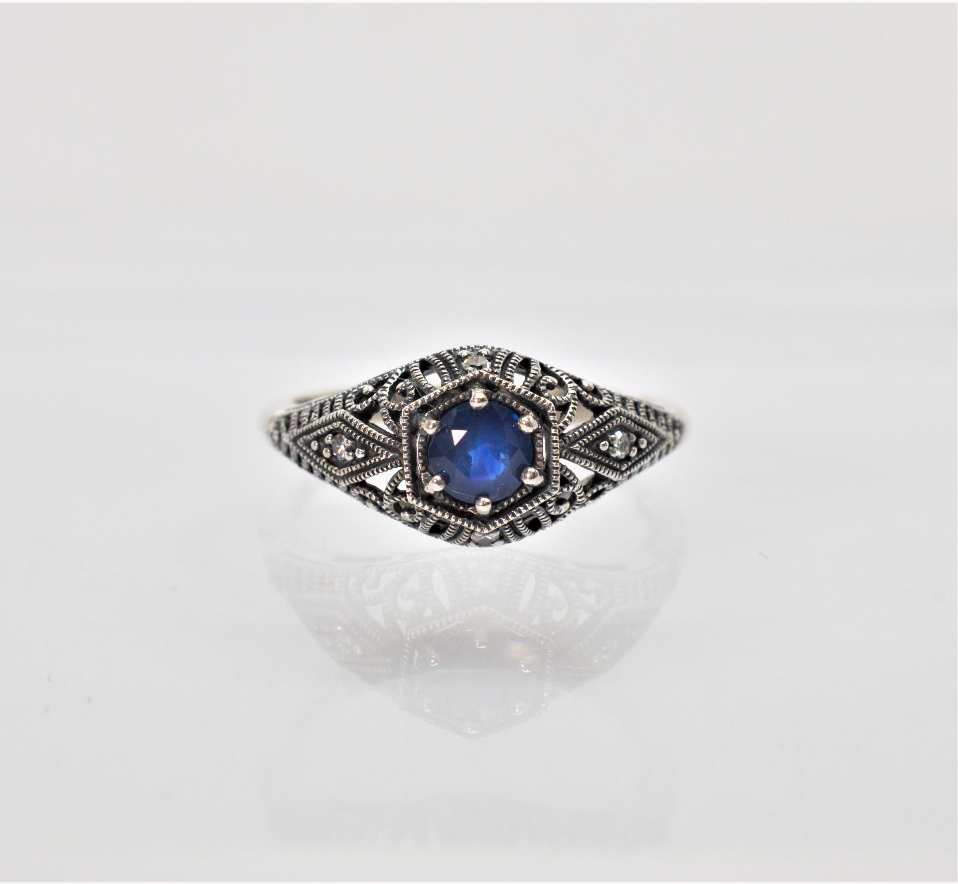 Vintage inspired design in sterling silver filigree with genuine gemstones. Enjoy this timeless design with exquisite detail reminiscent of the Art Deco Period. This ring has a center .25 round faceted blue sapphire with diamond accents. Comes in