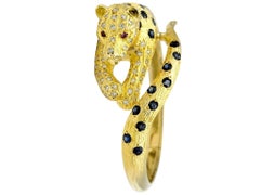 Blue Sapphire, Diamond and Ruby Panther Bangle Bracelet in 18 Karat Yellow Gold