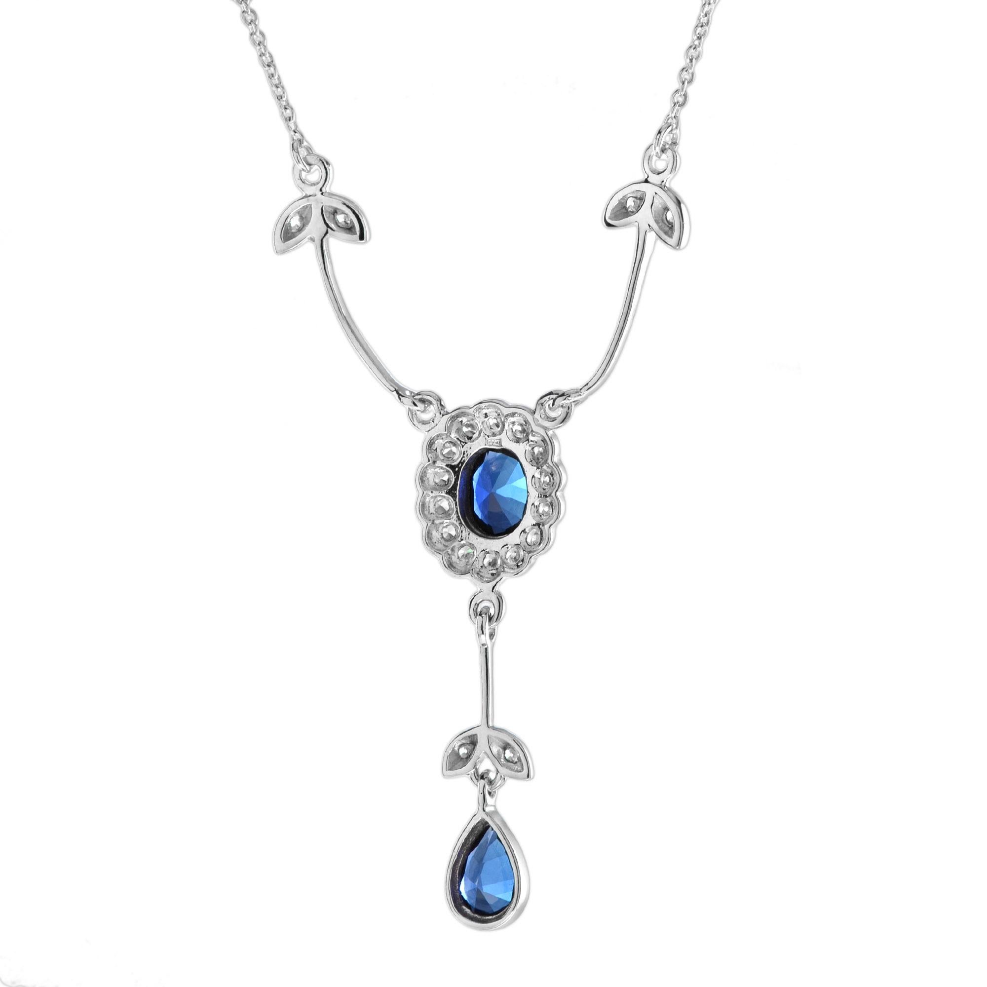 A really stunning white gold drop sapphire and diamond pendant on the original white gold chain. It is beautifully made in every detail. The sapphire is well-matched and is set into a stylized flower and leaf design. It is an original and very