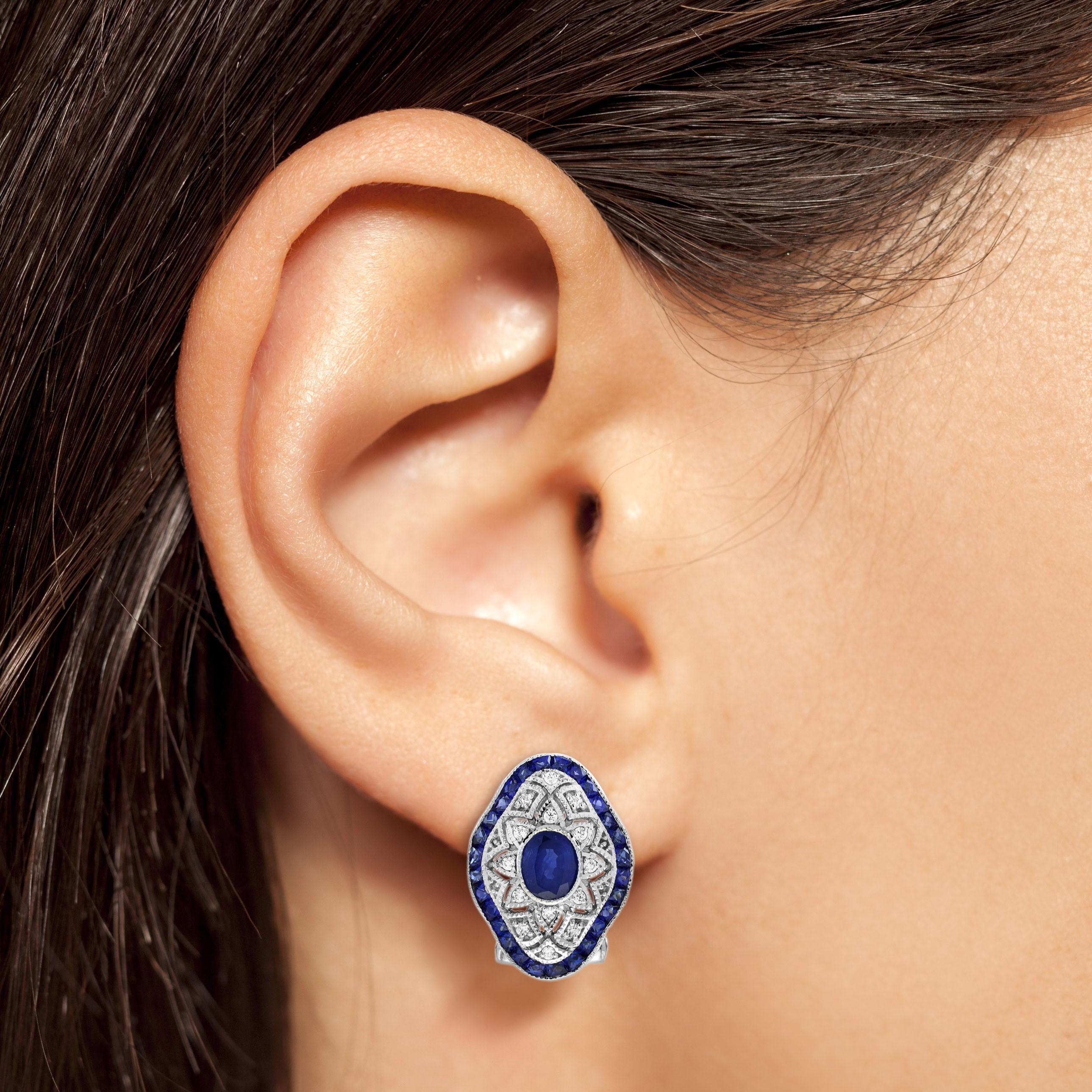 Step into the elegance of the Art Deco era with this stunning Blue Sapphire Diamond Art Deco Style Openwork Earrings, meticulously crafted in luxurious 18K white gold. At its heart sits a captivating oval-shaped blue sapphire, radiating deep,