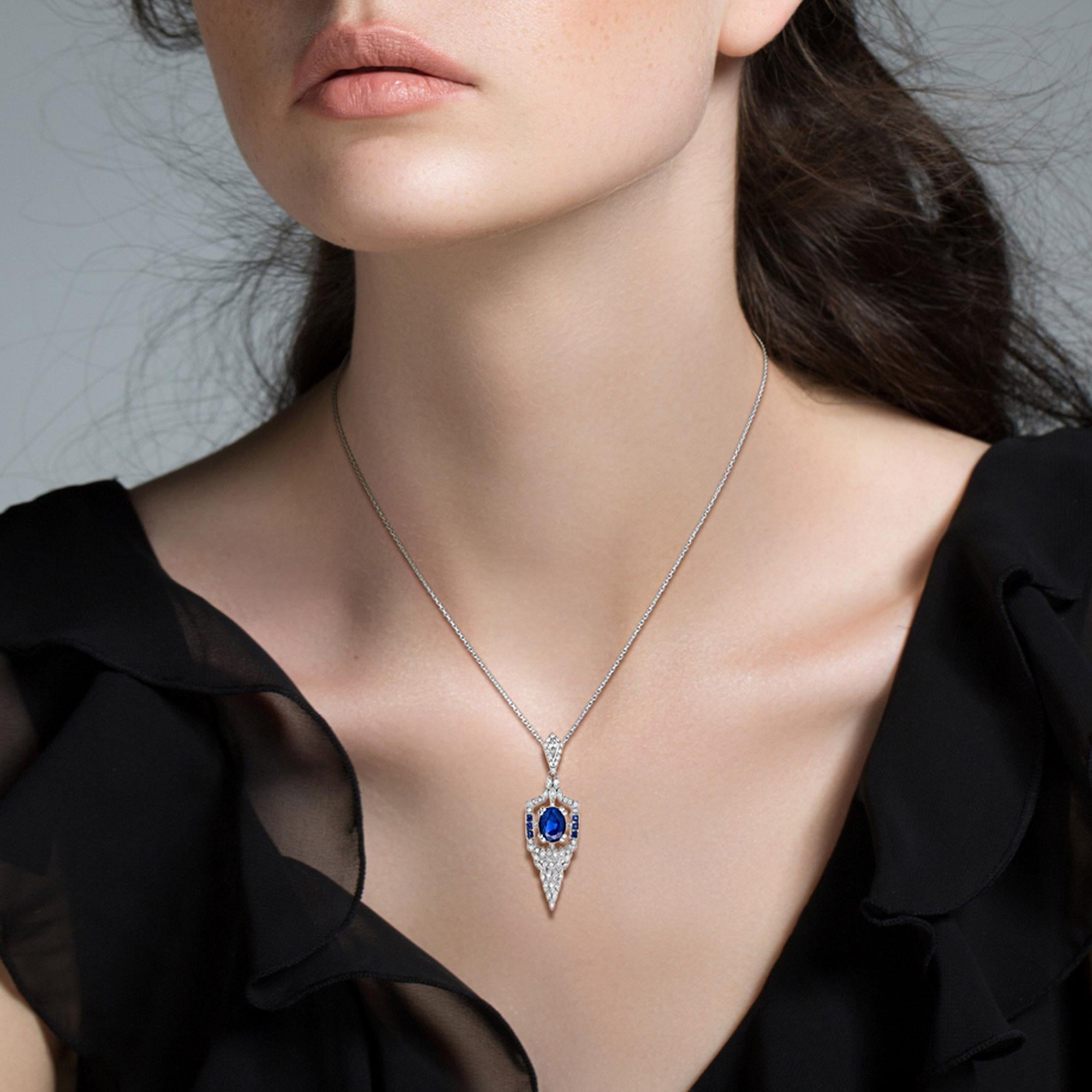 Transport yourself to an era of nostalgia with this exquisite pendant! Drawing inspiration from the iconic Art Deco movement, this stunning pendant showcases an approx. 1.6 carat oval cut blue sapphire floating in the heart, accented by total of .50