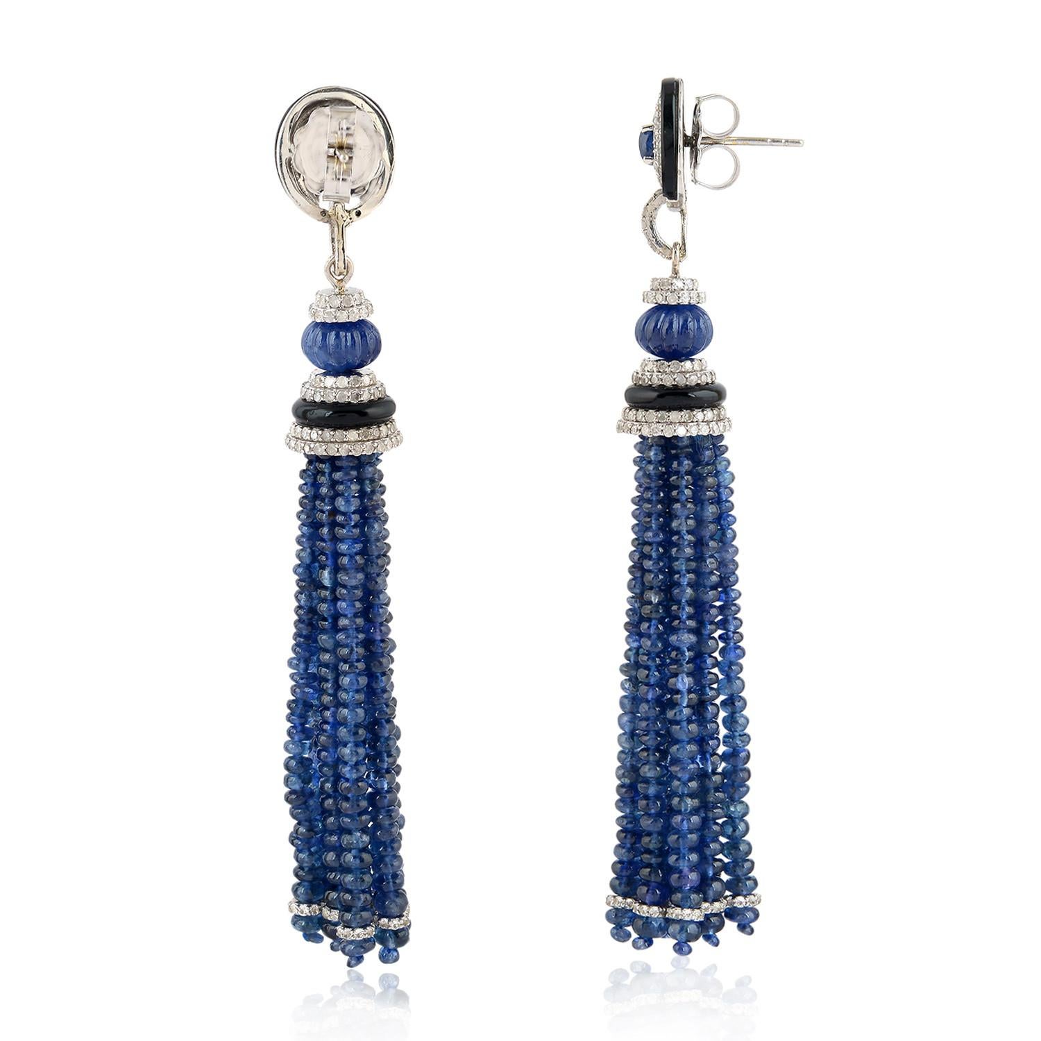 These stunning exceptional tassel earrings is handmade in 18-karat gold and sterling silver.  It is set with 93.19 carats blue sapphire, 3.05 carats black onyx and 2.29 carats of glittering diamonds.

FOLLOW  MEGHNA JEWELS storefront to view the