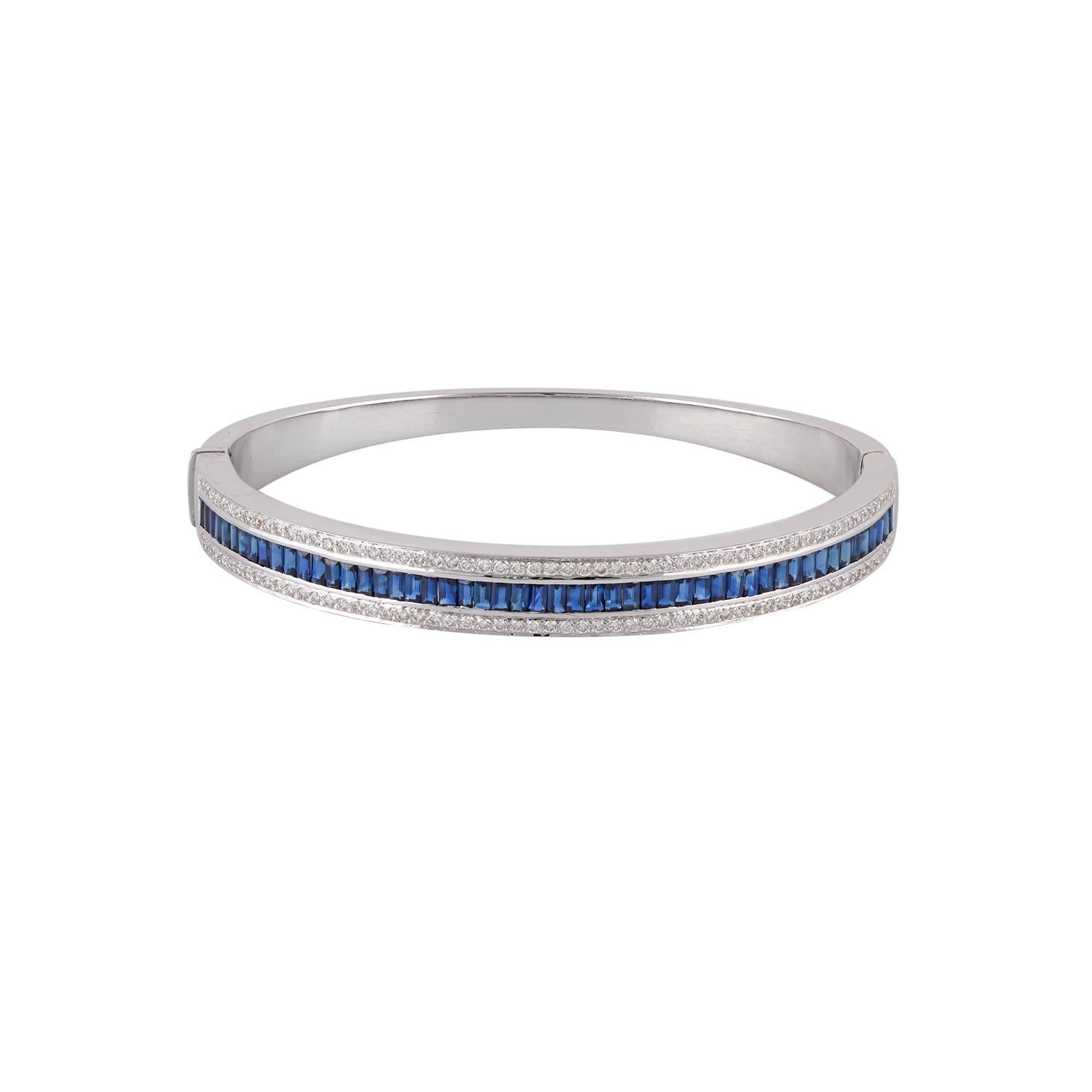 Its a classic bangle studded with blue sapphire & diamonds features 51 pieces of baguette shaped blue sapphires weight 3.58 carats with 114 pieces of round shaped diamonds weight 0.88 carats this bangle entirely made of 18k white gold weight 26.97