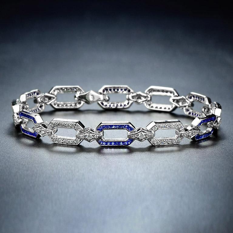 Featuring dazzling diamonds and sapphires, this Art Deco-style bracelet is beautifully made. It is geometric in design and symmetrical. The diamonds are a total weight of 1.50 carat approximately and are estimated as H in color and SI in clarity.