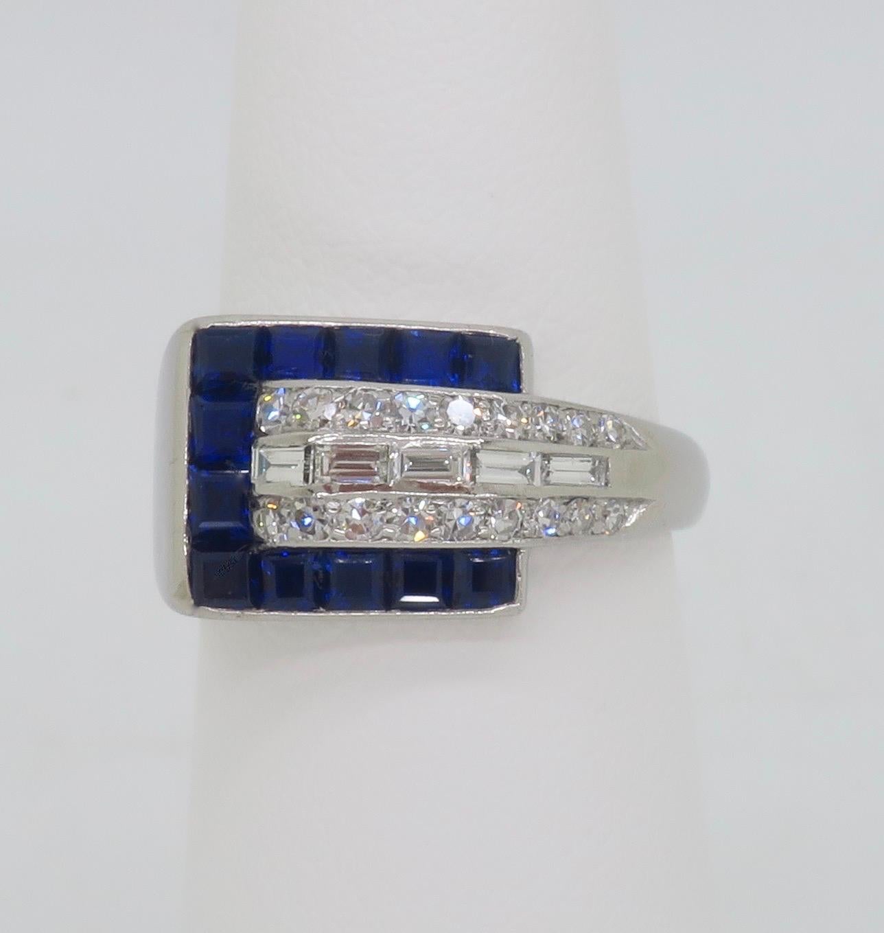 Beautiful Blue Sapphire & Diamond buckle style ring crafted in Platinum. 

Gemstone: Blue Sapphire & Diamond 
Diamond Carat Weight: .55CTW
Diamond Cut: Round Brilliant Cut Diamonds
Average Diamond Color: E-G
Average Diamond Clarity: VVS-VS
Blue